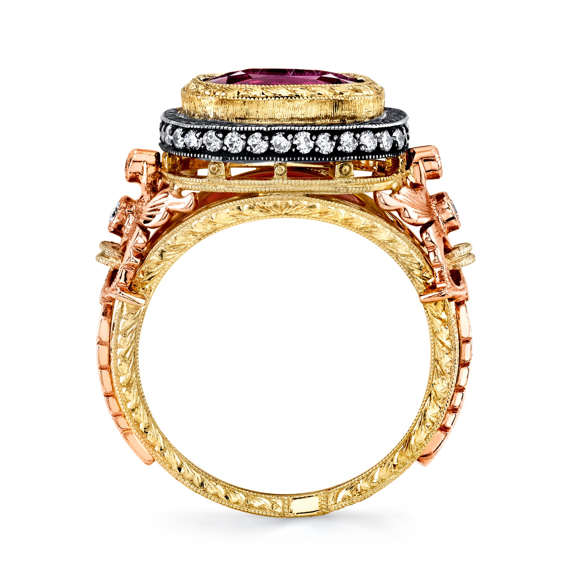 This beautifully handmade ring features a vibrant, hot pink sapphire cushion weighing 3.29 carats. The sapphire has rich, saturated color and is extremely brilliant with excellent clarity. It has been set in an engraved 18k yellow gold bezel and