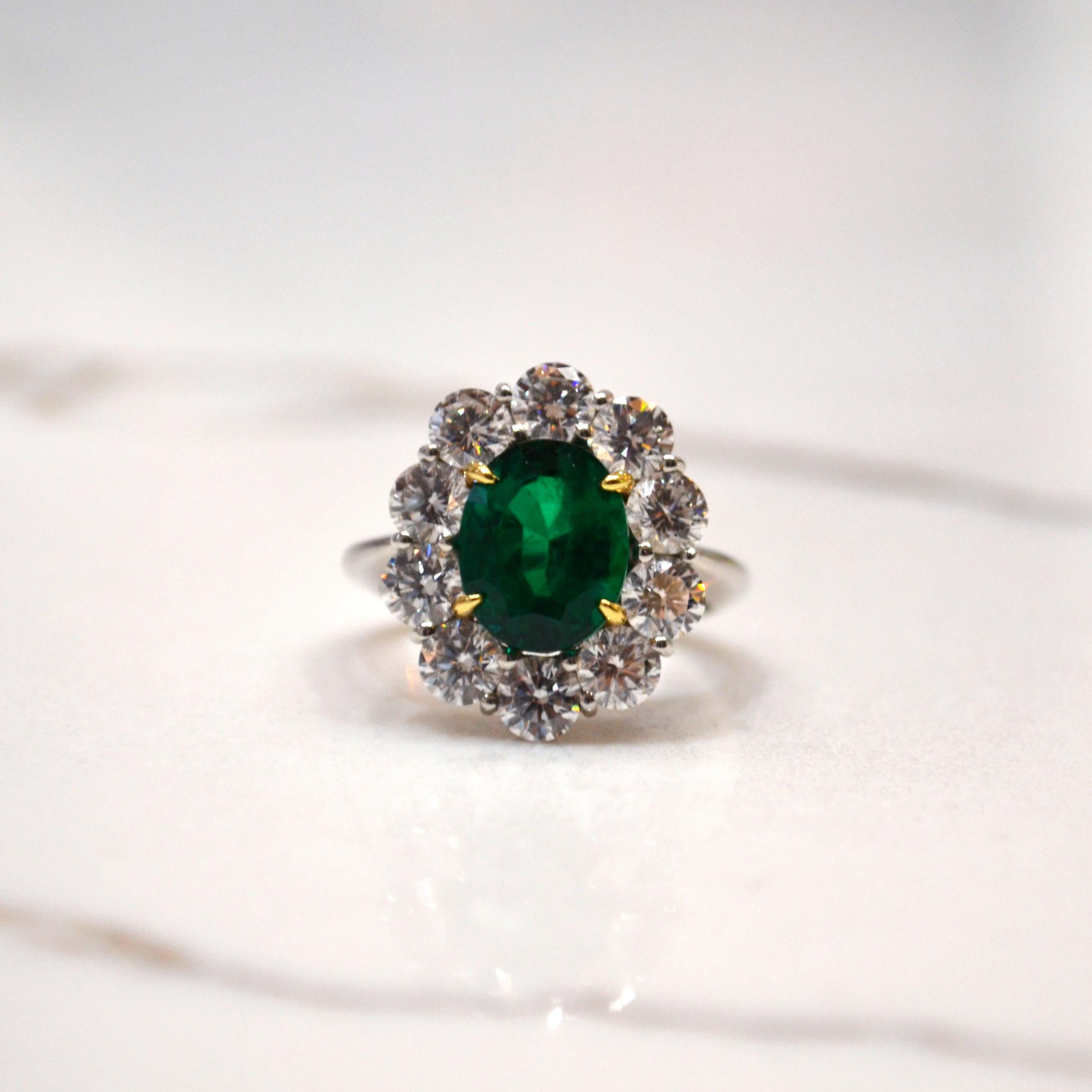 Ring in Platinum set with an oval Emerald (3.29 carat) and 10 round brilliant cut Diamonds (2.50 carat)

Includes Gemstone Report by AGTA. 
Ring US size 6
*Complimentary resizing service*
