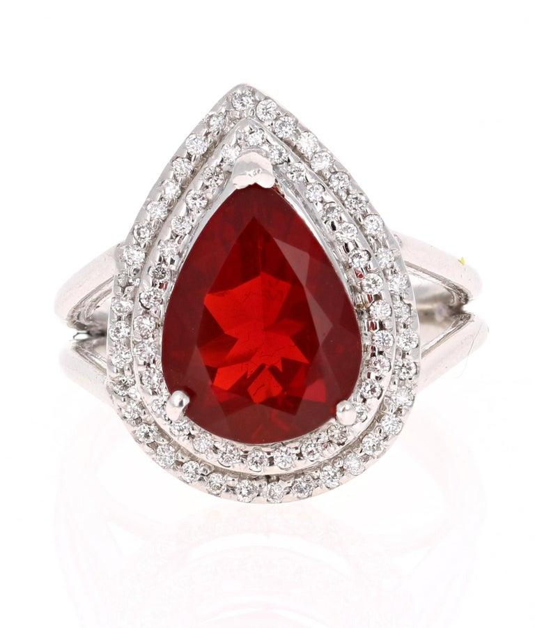 This ring has a 2.92 Carat Pear Cut Fire Opal. The hue is deep Red and is highly desirable. It is embellished with 72 Round Brilliant Cut Diamonds that weigh a total of 0.37 carats. The Clarity and Color of the diamonds are VS-F.  

The ring is