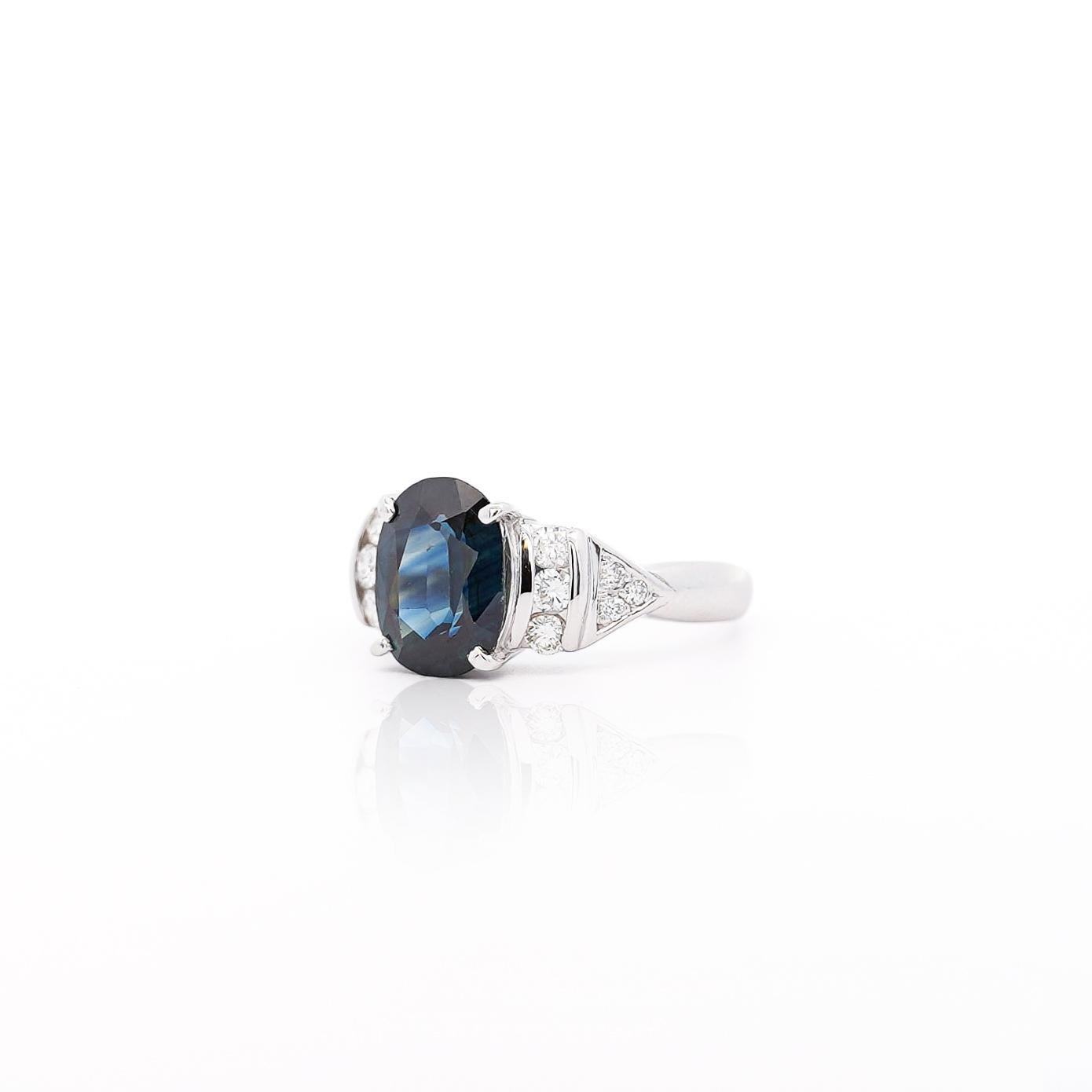 A platinum engagement ring featuring a 3.29-carat oval cut dark blue sapphire, flanked by round cut white diamonds for an effortlessly elegant look.

Details:
Item Type: Engagement Ring
Metal: Platinum 900 (Hypoallergenic and safe for daily wear,