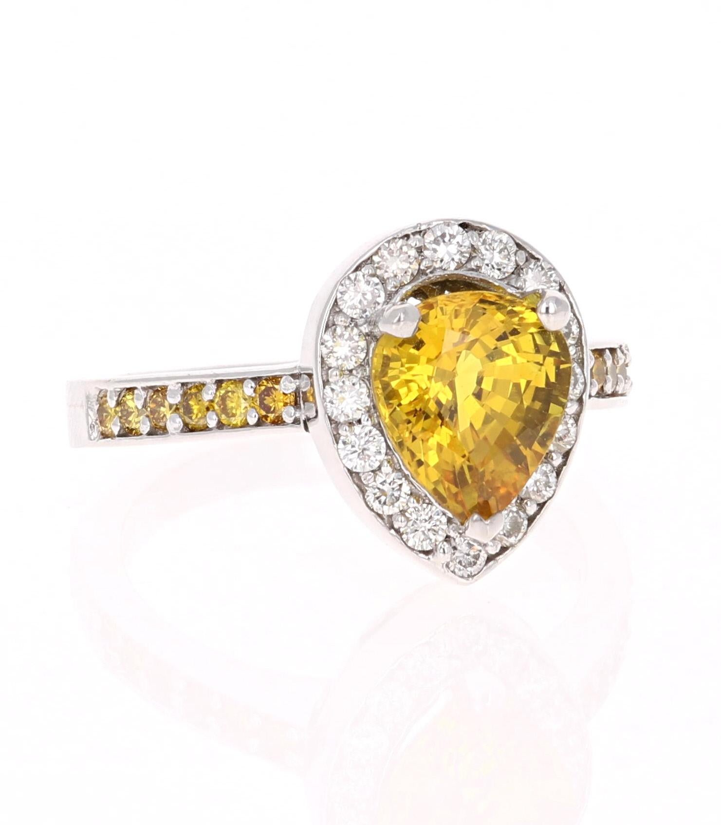 A unique Yellow Sapphire, Yellow and White Diamond Ring that can be a beautiful Engagement Ring. 
The Pear Cut Yellow Sapphire is 2.66 Carats. 
It has a halo of 16 Round Cut White Diamonds that weigh 0.37 Carats (Clarity: VS2, Color: H).  The shank