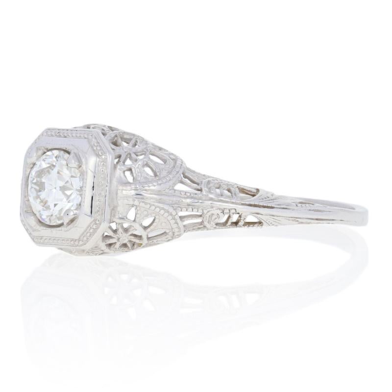 Put the sparkle into your bride’s eyes when you propose with an elegant Art Deco engagement ring! Dating from circa 1920’s-1930’s, this white gold ring features a natural diamond solitaire in a milgrain-bordered mounting. The filigree detailing