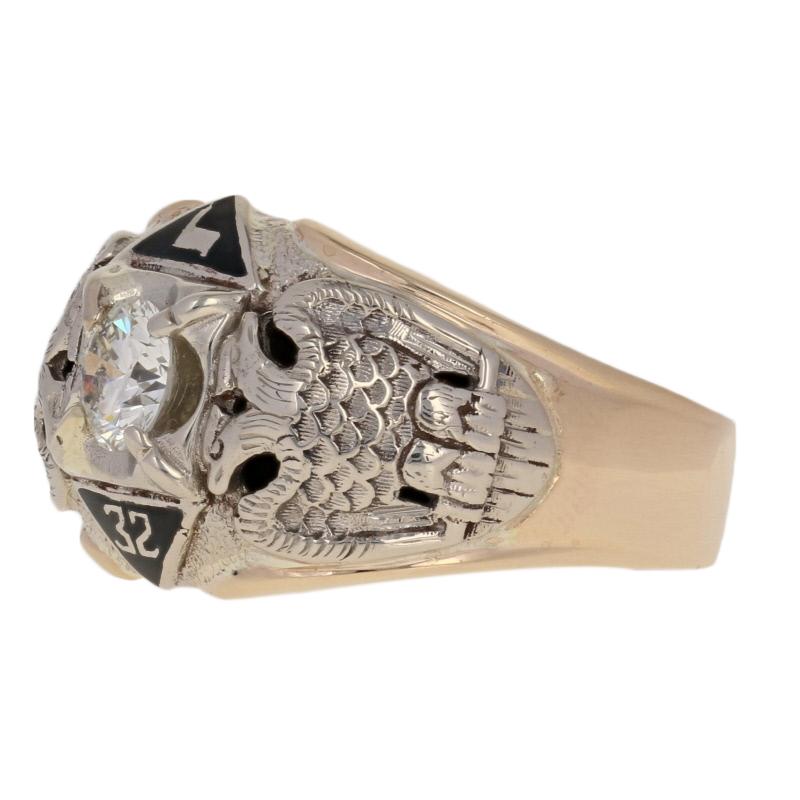 Crafted in 14k yellow and white gold, this 32nd degree Scottish Rite ring showcases a radiant white diamond handsomely framed by masonic images. The ring’s tapered shoulders display etched double-headed eagles while the bridge is highlighted with