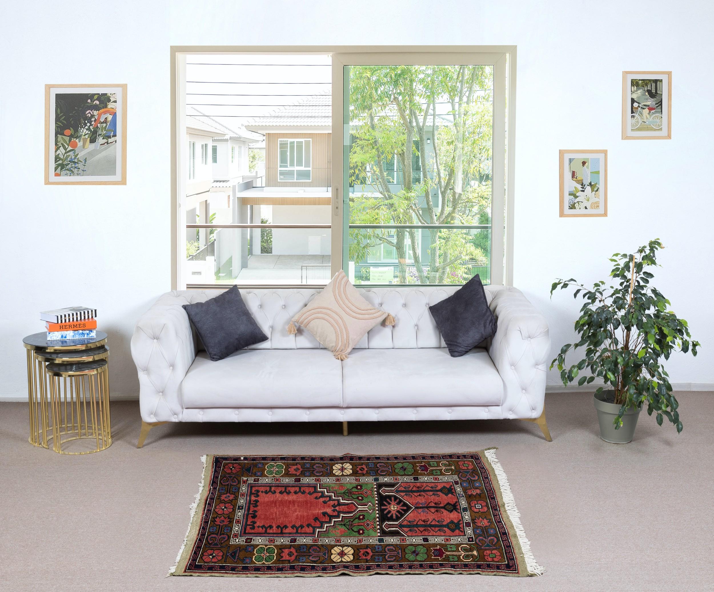 Experience the beauty of tradition with this vintage handmade Turkish prayer rug, expertly crafted from 100% wool. A symbol of devotion and artistry, this rug features an elegant mihrab (prayer niche) design, reflecting the rich spiritual and