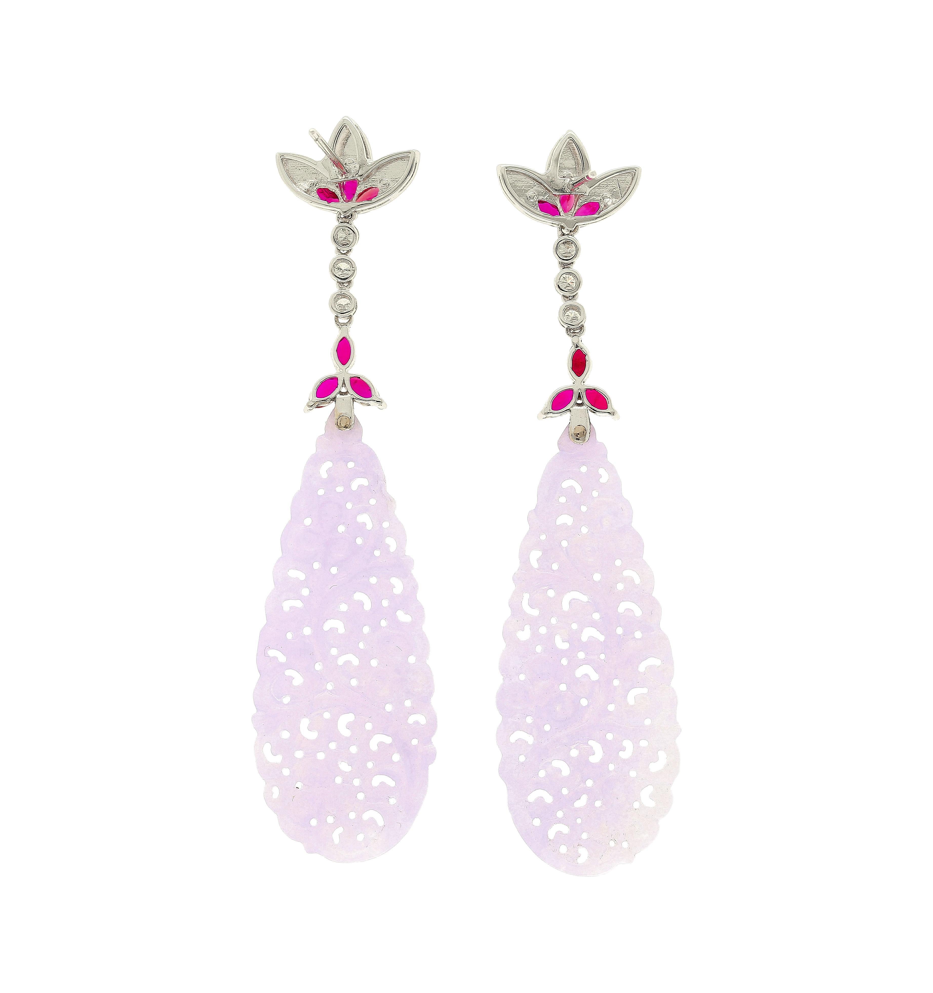 33.02 carat carved grade a lavender jade drop earrings. Adorned with 12 marquise cut rubies, 6 at the base of the ear and 6 at the base of the connection to the jade, 1.73 cttw. 
3 round cut bezel set diamonds connecting the base of the earring to