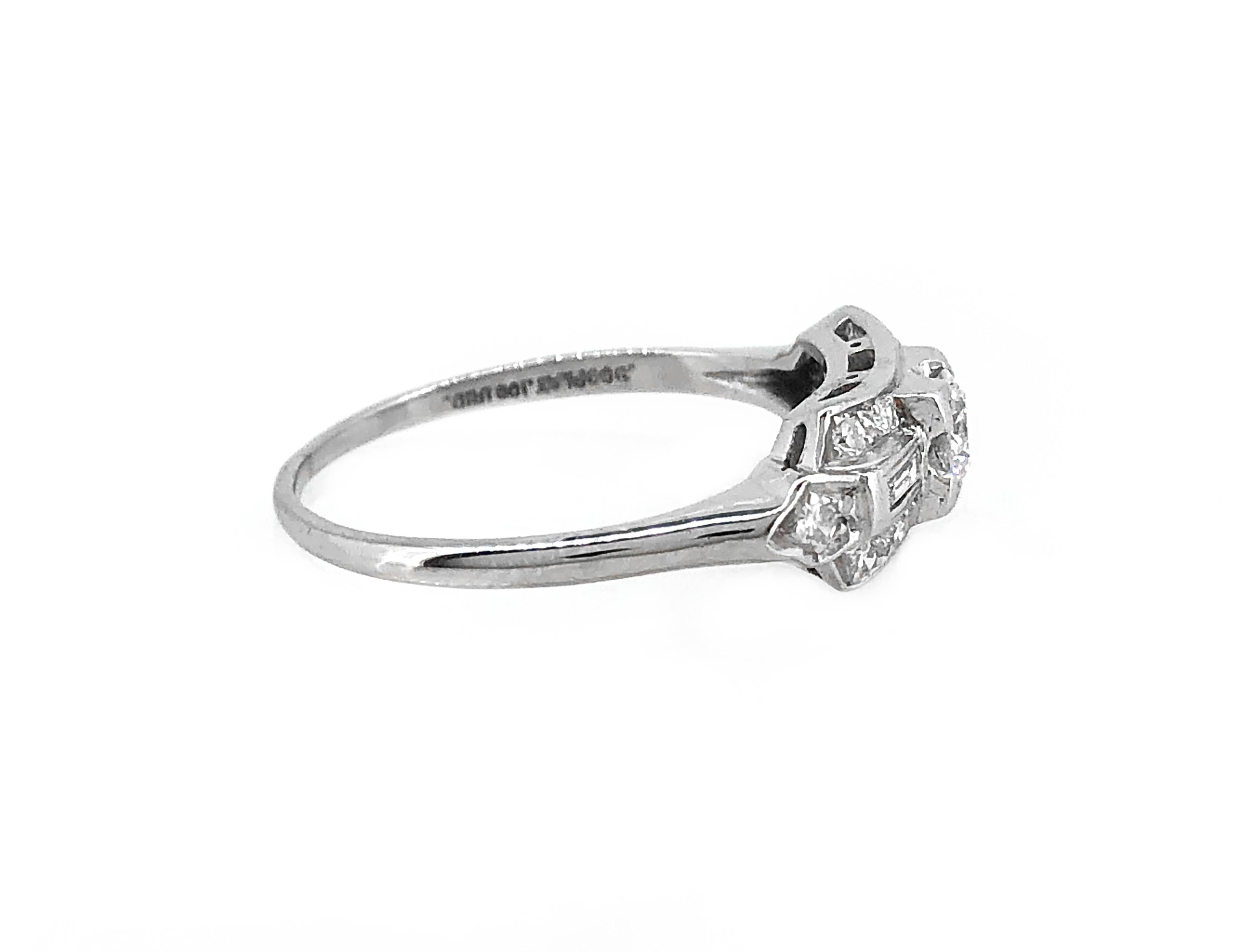 A sizzling Art Deco diamond Antique engagement or fashion ring that features a scintillating .33ct. apx. transitional cut diamond with fantastic VS2 clarity and G color. Baguette and single cut diamonds weighing .25ct. apx. T.W. decorate this lovely