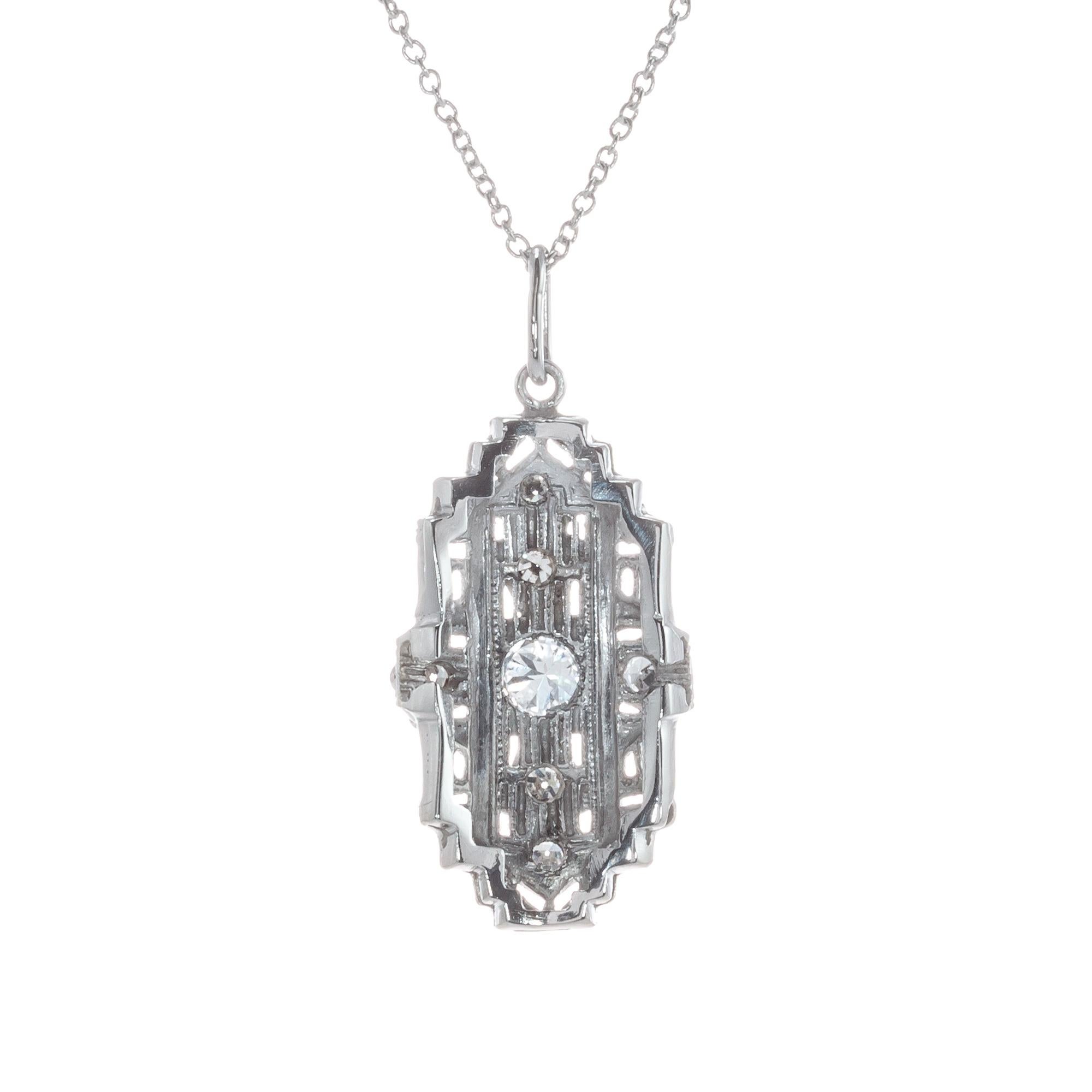 1920's Art Deco platinum diamond pierced filigree pendant and necklace.

1 round H VS2 Diamond, Approximate .15ct 
6 single cut H-I VS diamonds, Approximate .18cts
Chain: 18 Inches
Platinum 
Stamped: PT950
4.2 Grams
Top to Bottom: 24.9mm or 1