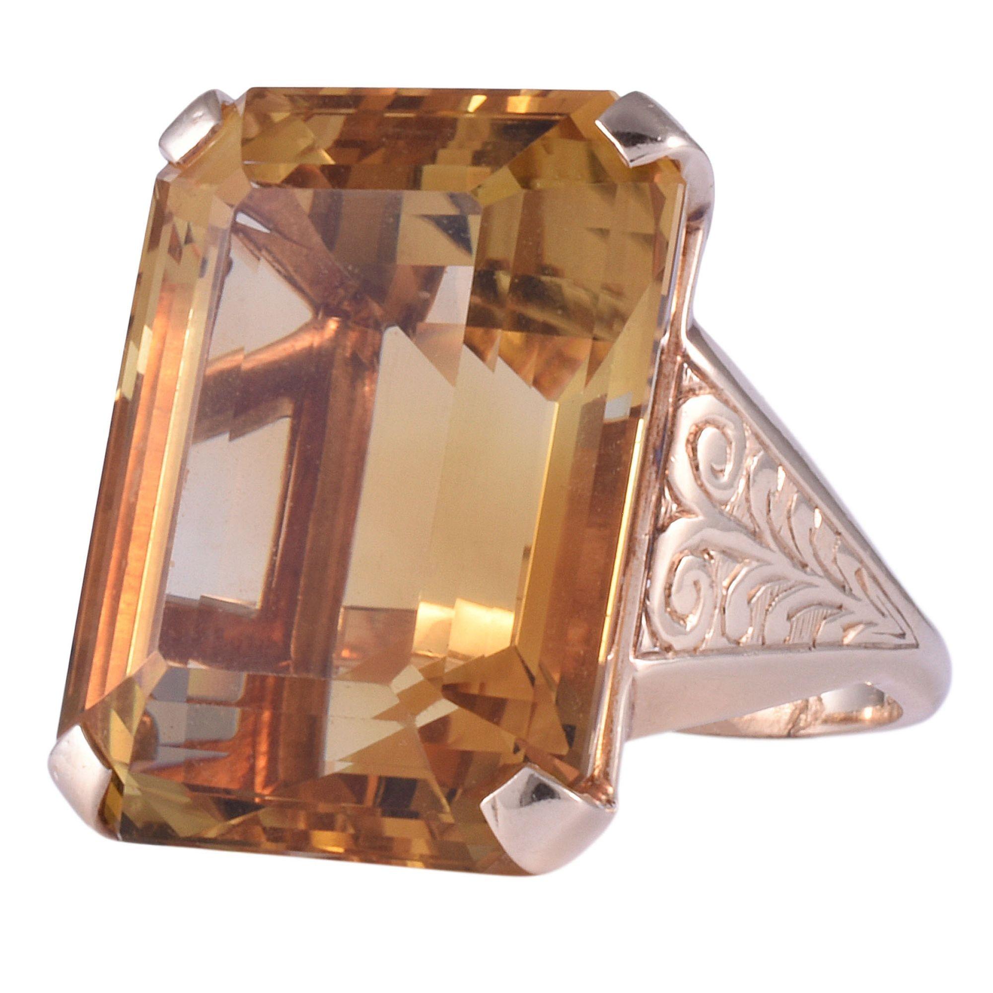 Vintage 33 carat natural untreated citrine 14K gold ring, circa 1950. This vintage ring is crafted in 14 karat yellow gold featuring hand engraving. The vintage engraved ring boasts a rare 33 carat natural untreated citrine. This unique citrine ring