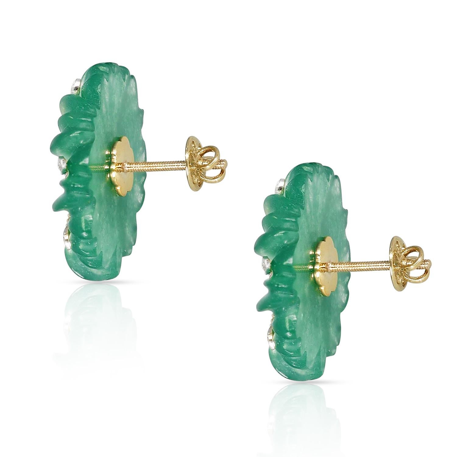 A beautiful pair of carved Jade earrings in an oval shape with a floral design made up of white and yellow gold with diamonds. Diamond Weight:  0.13 cts, Jade Weight: 33.11  cts. 14K Gold. Total Weight: 9.52 grams. Matching Pendant available.