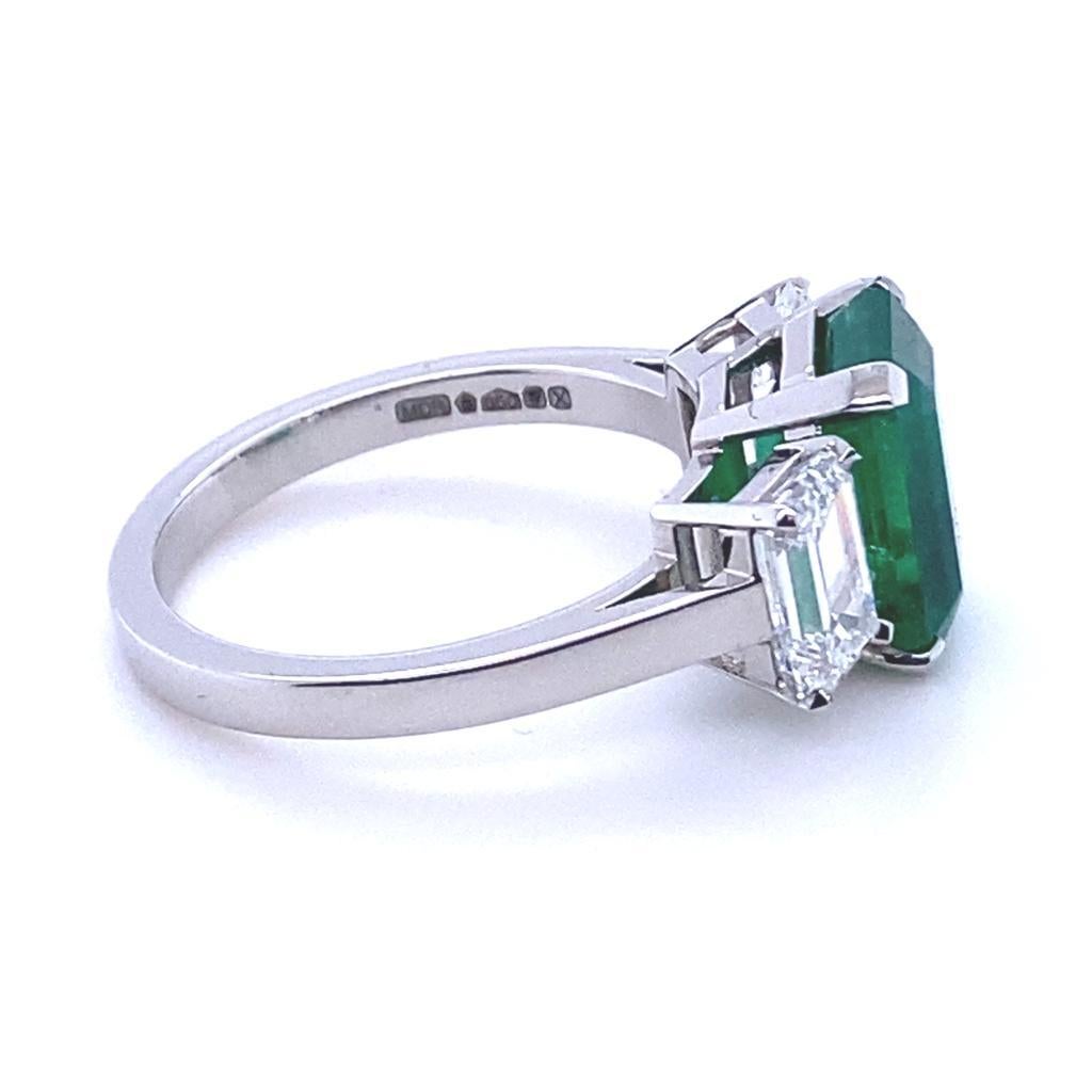 A 3.30 carat Columbian emerald and diamond three stone platinum engagement ring.

This beautiful emerald and diamond engagement ring is handcrafted in platinum. The piece is claw set to its centre with an exceptional emerald cut emerald of 3.30