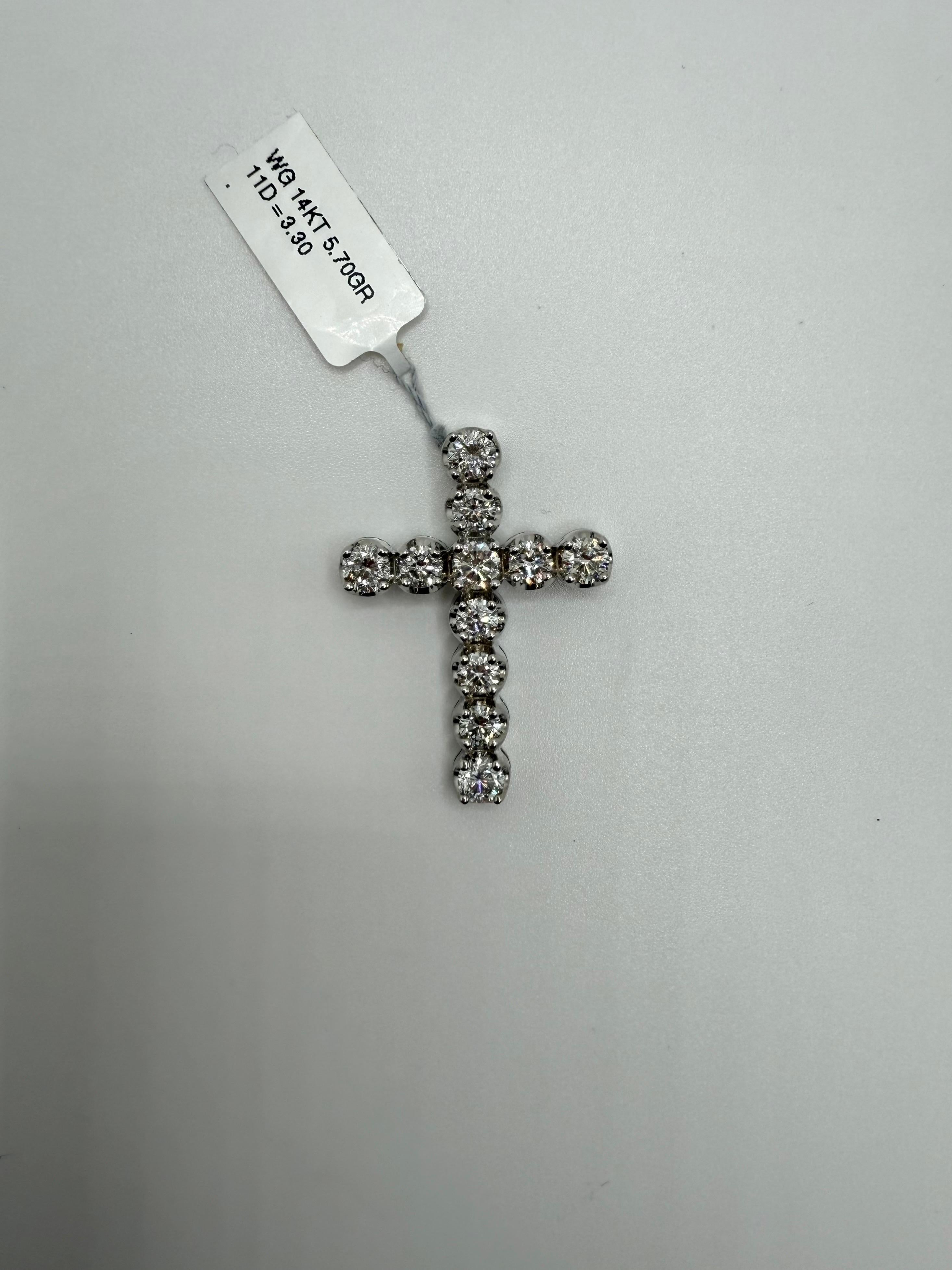 This timeless diamond cross pendant is crafted in 14K white gold and showcases a classic yet elegant design. Measuring 1.45 inches in length and weighing 5.70 grams, the pendant features a total of 3.30 carats of round brilliant diamonds, carefully