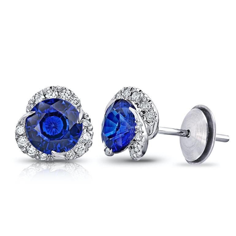 Two round blue sapphires weighing 3.30 carats set with 30 round diamonds weighing .39 carats (F+ VVS/VS+). Set in hand made platinum