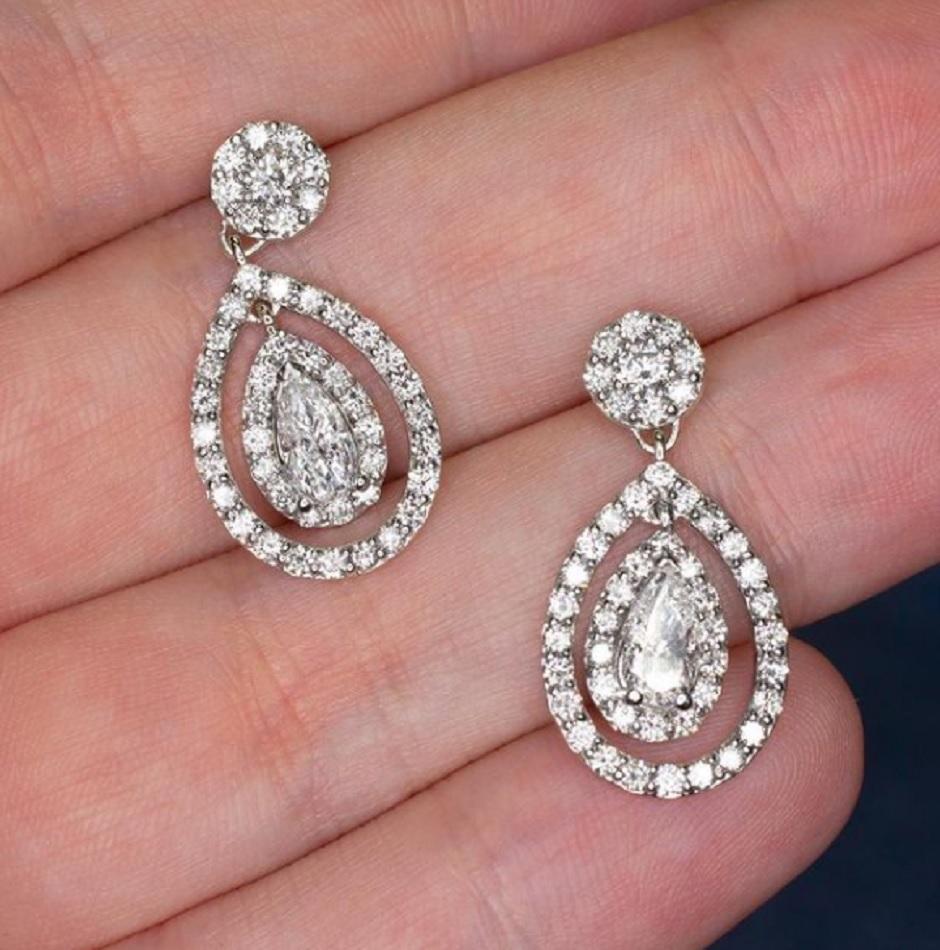 Shimmering with 3.30 carats of very high quality and dazzlingly vibrant natural diamonds, these striking earrings offer eye-catching sparkle and charming movement. The drops feature a 1 pair of complete eye clean pear cut diamonds with perfectly