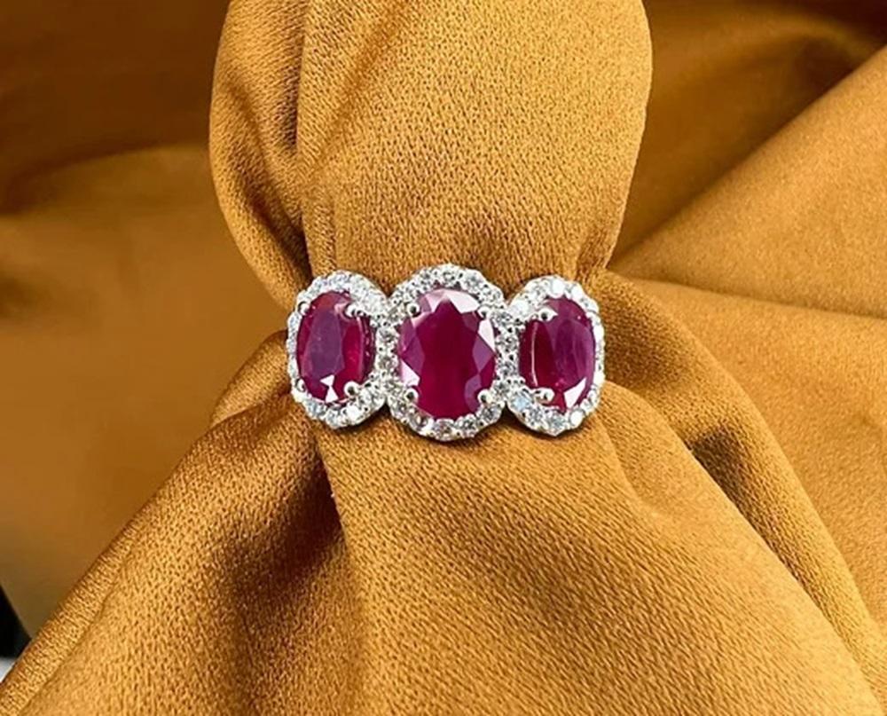 Ruby Weight: 3.30 CTs, Measurements: 8x6/7x5 mm, Diamond Weight: 0.48 CTs, Metal: 18K White Gold, Gold Weight: 5.46 gm, Ring Size: 7, Shape: Oval, Color: Red, Hardness: 9, Birthstone: July