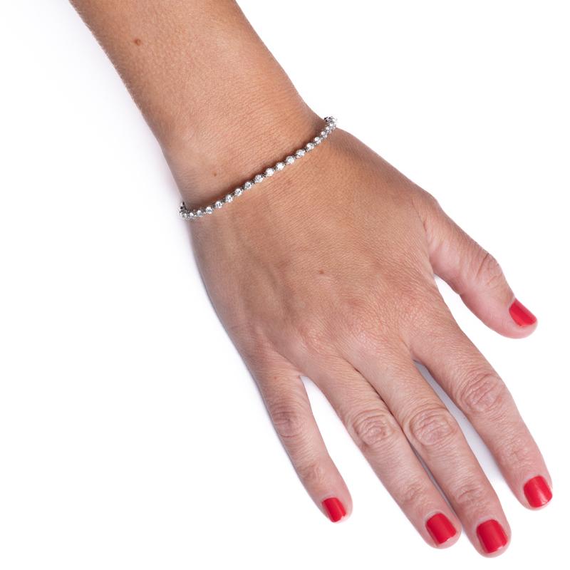This gorgeous tennis bracelet features 41 round brilliant cut natural diamonds weighing approximately 3.30 carats total weight. They are set in a single-prong setting in 14 karat white gold. Wear alone or layer with all your other favorite