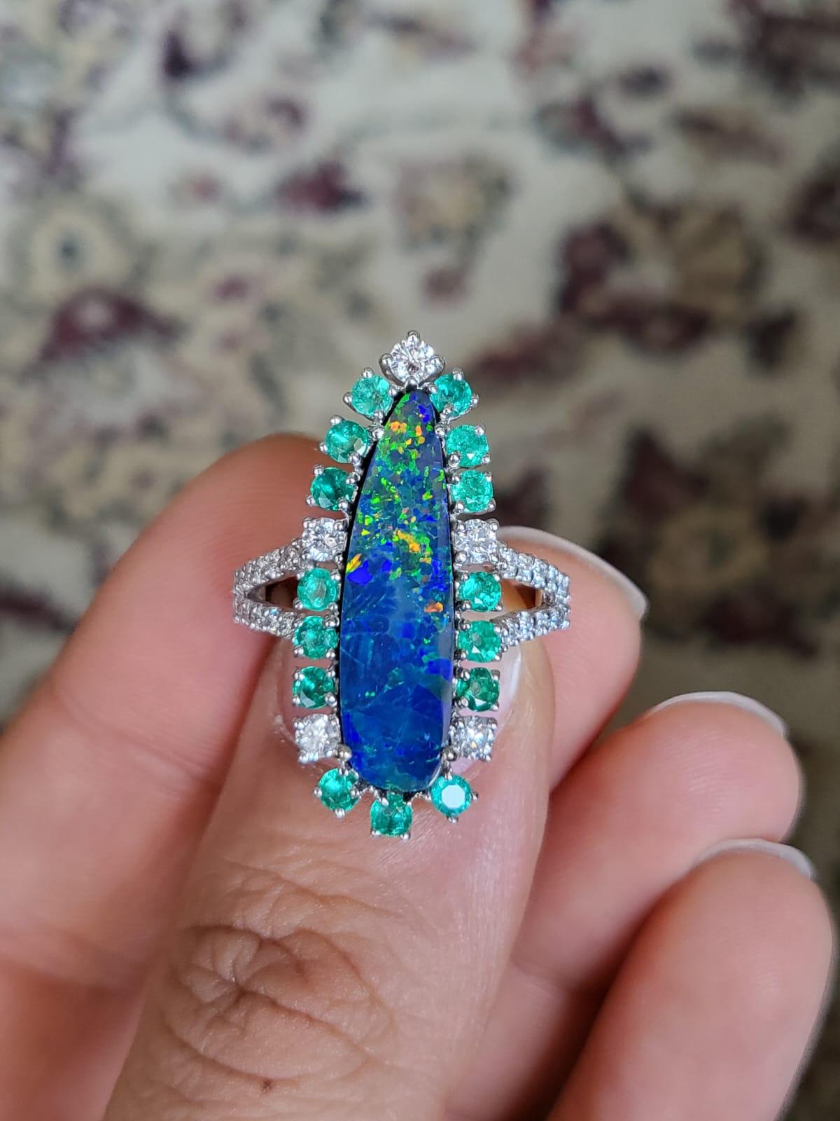 A very gorgeous, one of a kind and modern, Doublet Opal & Emerald Cocktail Ring set in 18K White Gold & Diamonds. The weight of the Doublet Opal is 3.30 carats. The Doublet Opal is of Australian origin and has a green, blue & orange play of colour.