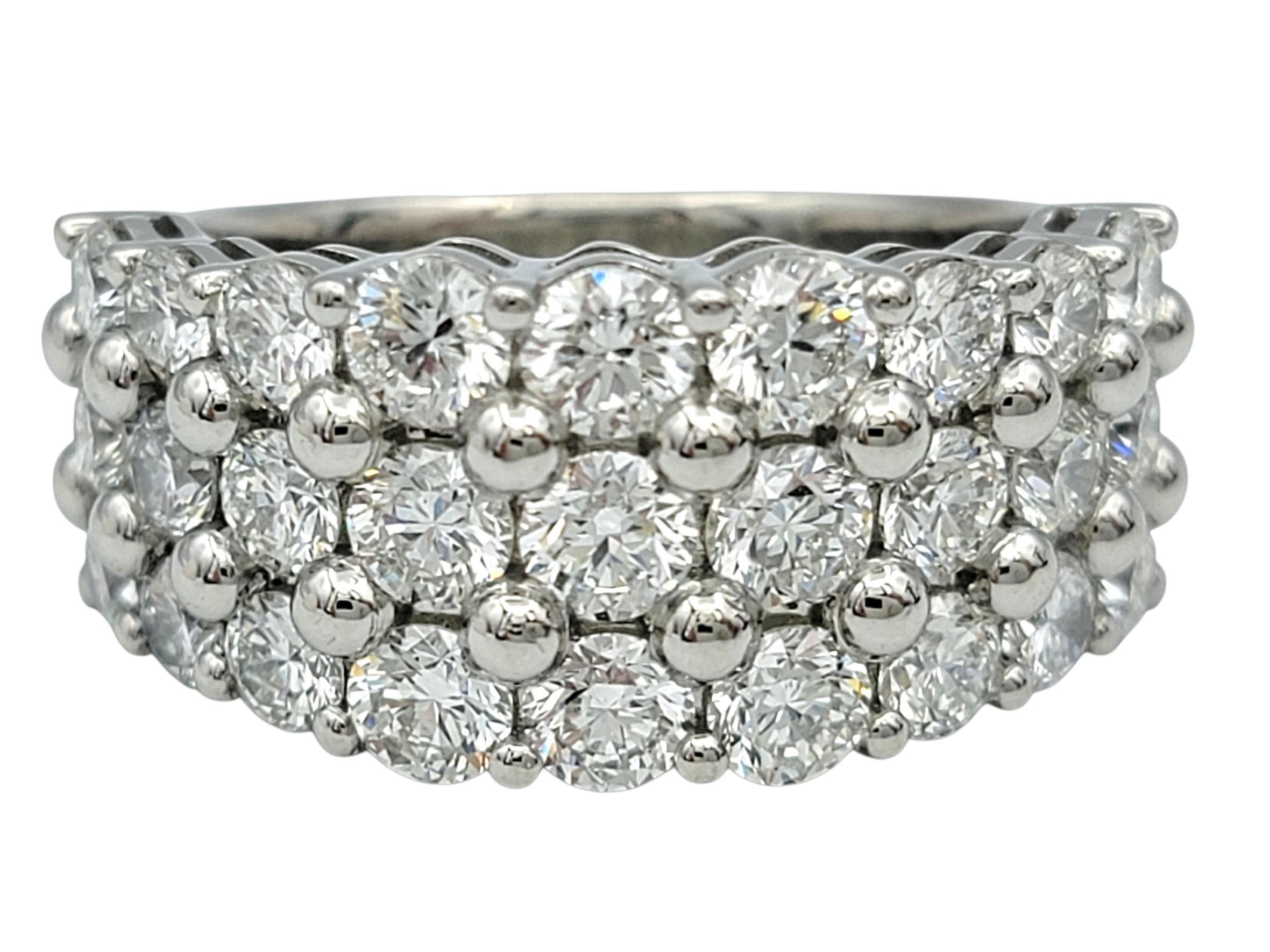This ring shines with three full rows of bright white stones that create a shimmering, layered effect across the finger. Each diamond sits closely beside the next, forming a continuous surface of sparkle that catches the light from every angle. The