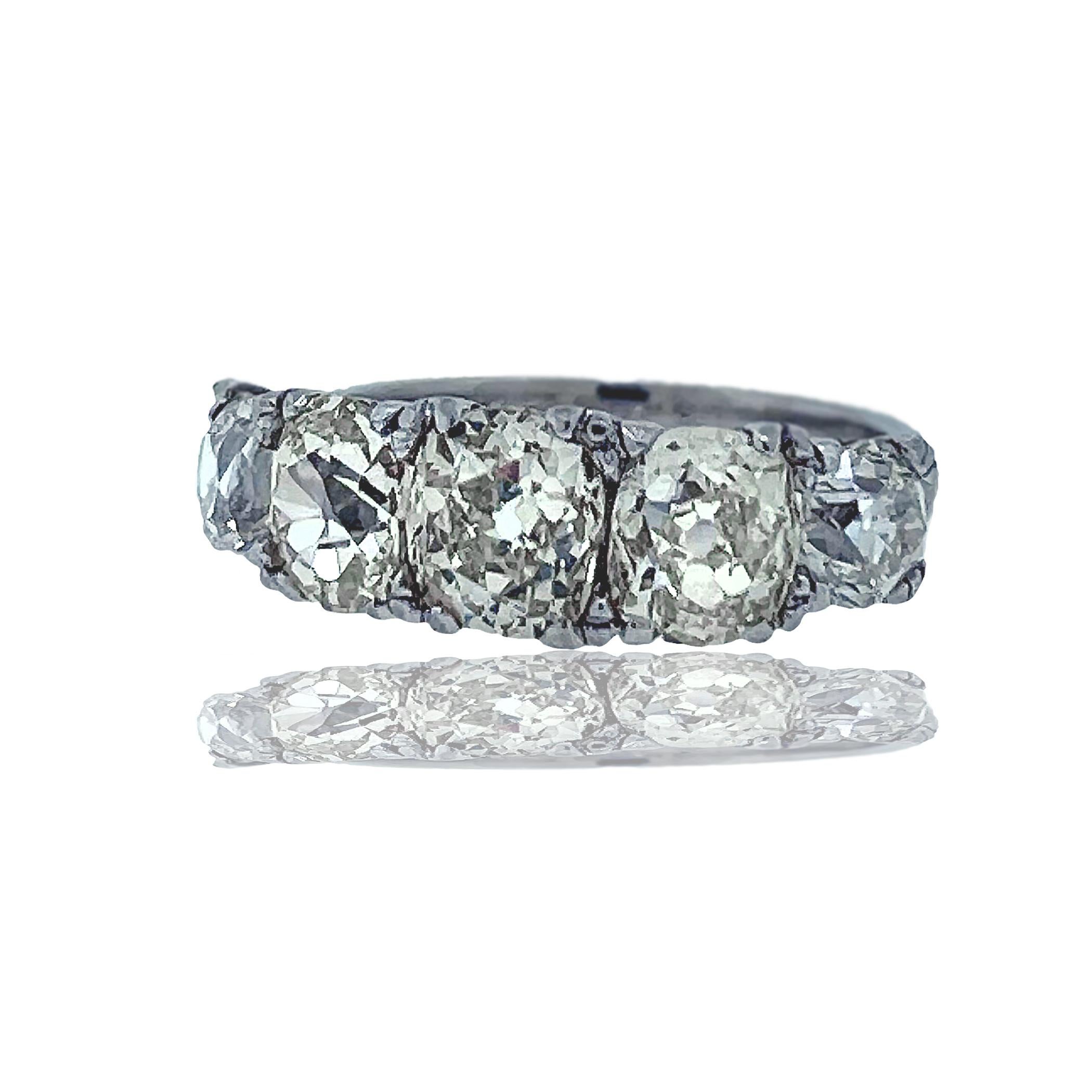 A beautiful 5-stone diamond mine cut platinum ring.  The diamond range in color, clarity, and size from the following; 6 x 5.15 mm, 5.75 x 4.85 mm, 5.75 x 4.9mm, 4.39 x 3.4 mm, 4.5 x 4.5 mm. The color and clarity range from M-N J-K and VS-SI.  This