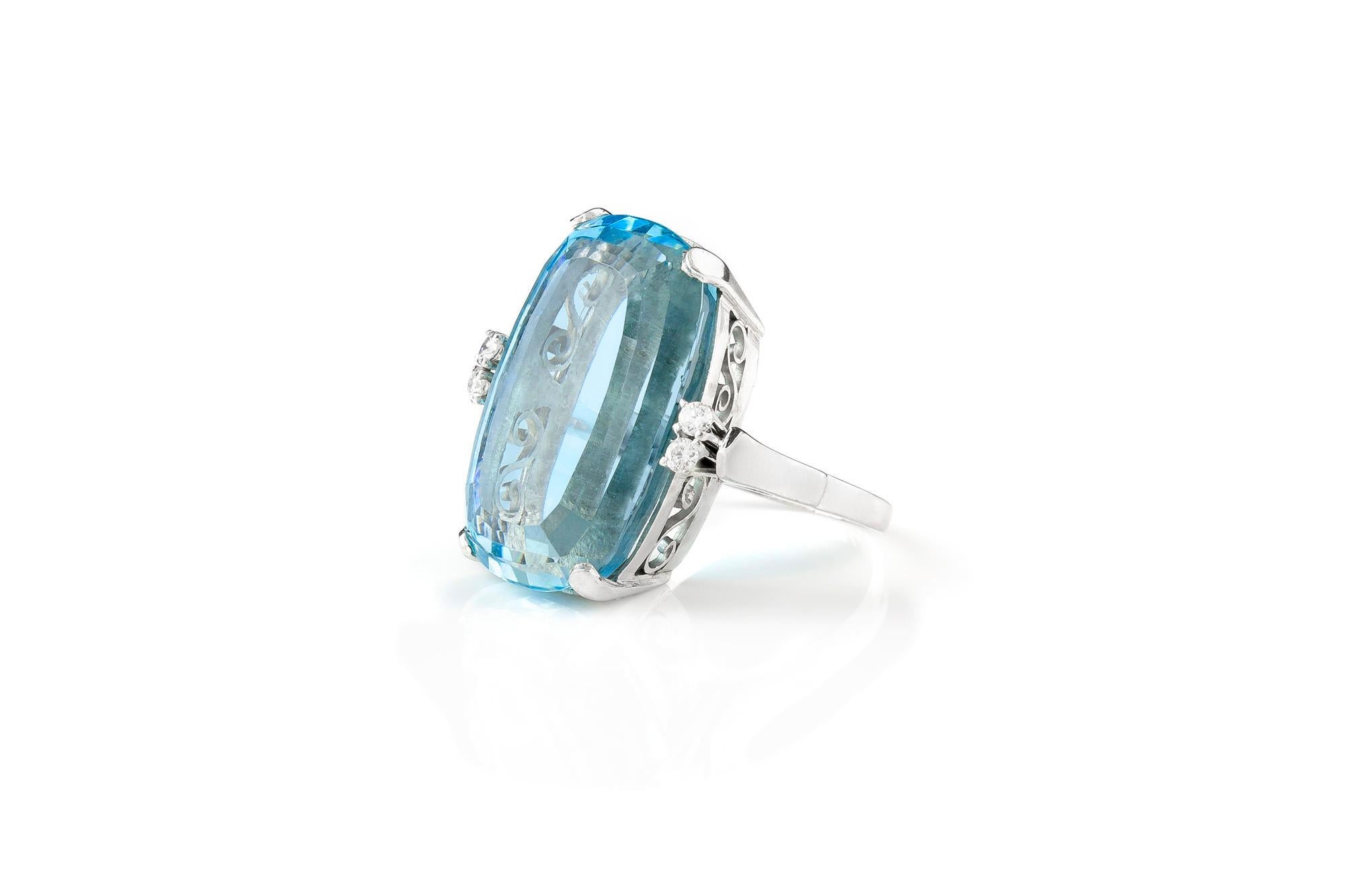 Finely crafted in platinum with a cushion cut Aquamarine weighing approximately 33.00 carats.
The center stone is flanked with 4 round brilliant cut diamonds, weighing approximately a total of 0.20 carats.
Art Deco, circa 1930's.
Size 5 3/4,