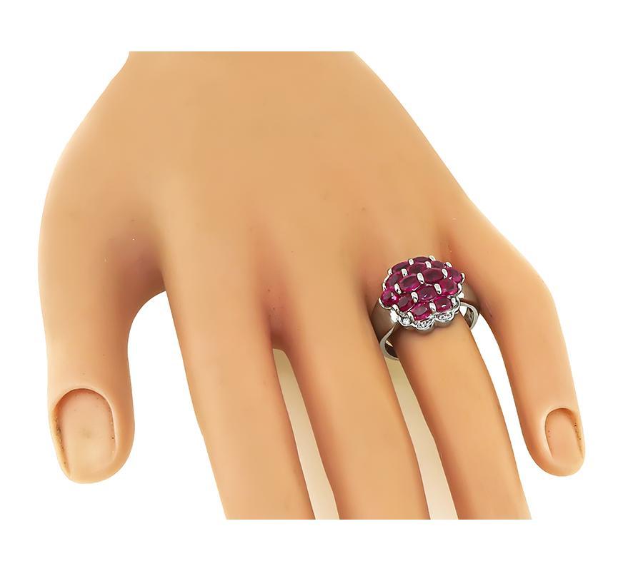 This is a charming platinum ring. The ring is set with lovely oval cut rubies that weigh approximately 3.30ct. The rubies are accentuated by sparkling round cut diamonds that weigh approximately 0.12ct. The color of the diamonds is H with VS