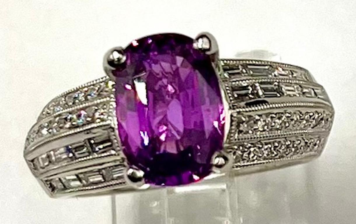 This is a very beautiful and very vibrant Purplish Pink Sapphire. The color is very rich and very saturated and the distribution of color is very even. The design of the ring is very simple and elegant and is meant to focus on and highlight the