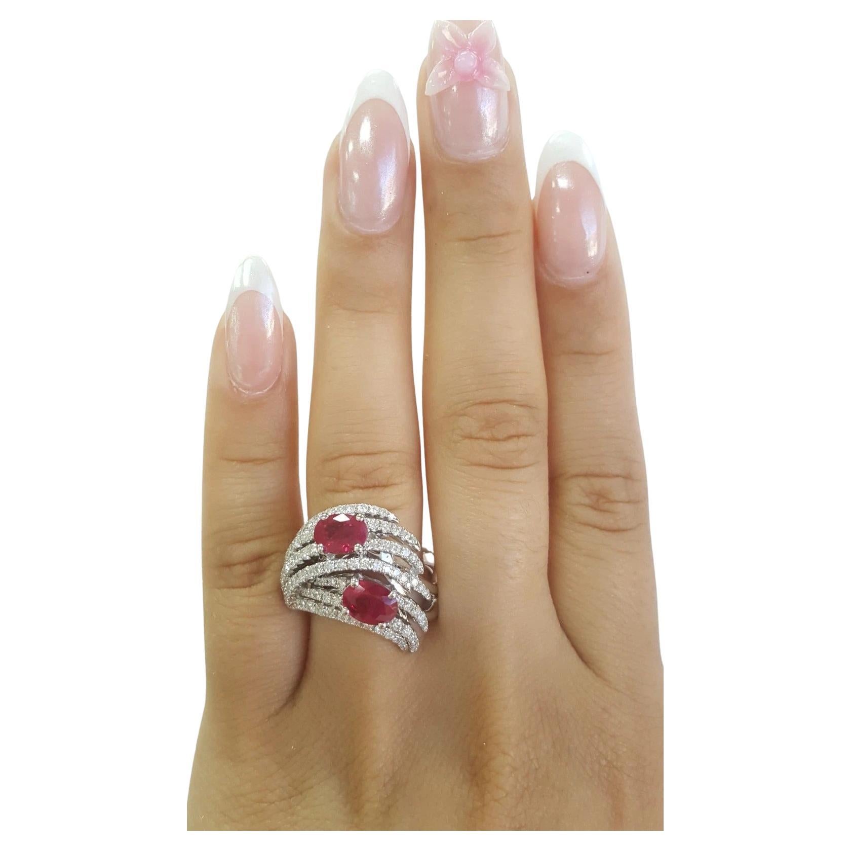 3.31 Carat Oval Ruby & Diamond Statement Ring in 18K White Gold

This striking statement ring showcases two natural oval-shaped Pigeon Blood Burma rubies with a combined weight of approximately 2.42 carats. Their rich, vivid red hue is beautifully