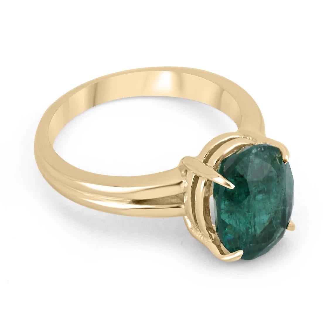 A stunning, solitaire, natural emerald ring. Enthrall in this gorgeous piece, as it displays a lively oval cut natural Zambian emerald with a desirable dark forest green color and excellent luster as some of its many remarkable characteristics. Set