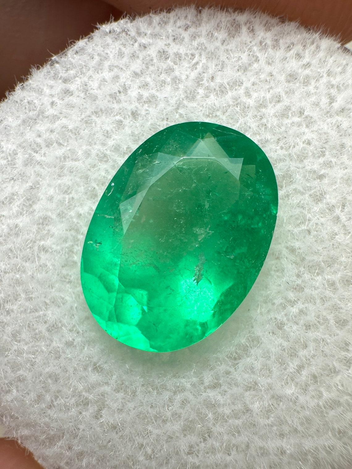 Stone: Emerald
Weight: 3.32-carats
Shape: Oval Cut
Clarity: Transparent to Semi-Transparent
Luster: Very Good
Color: Neon Yellowish Green
Measurements: 12.06mm x 8.74mm x 5.60mm
Geographic Origin: Colombia
Treatment: Natural, Oiling

Comments: Due