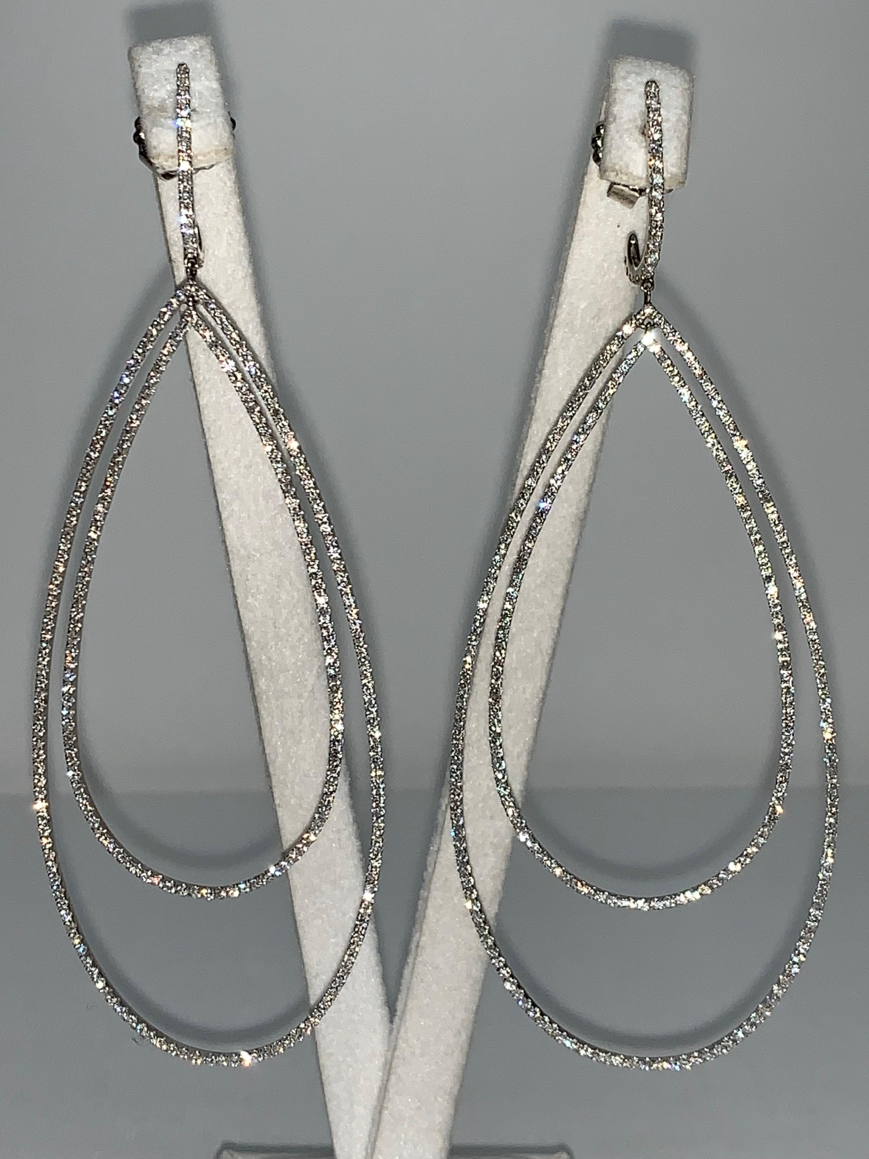 White Pavé Diamond, White Gold Double Tear Drop Earrings. 

Featuring a pair of White Pavé Diamond Tear Drop Earrings with a total weight of 3.32 carats, set in 18K White Gold. 

This one-of-a-kind pair of earrings was created by hand and in CAD,