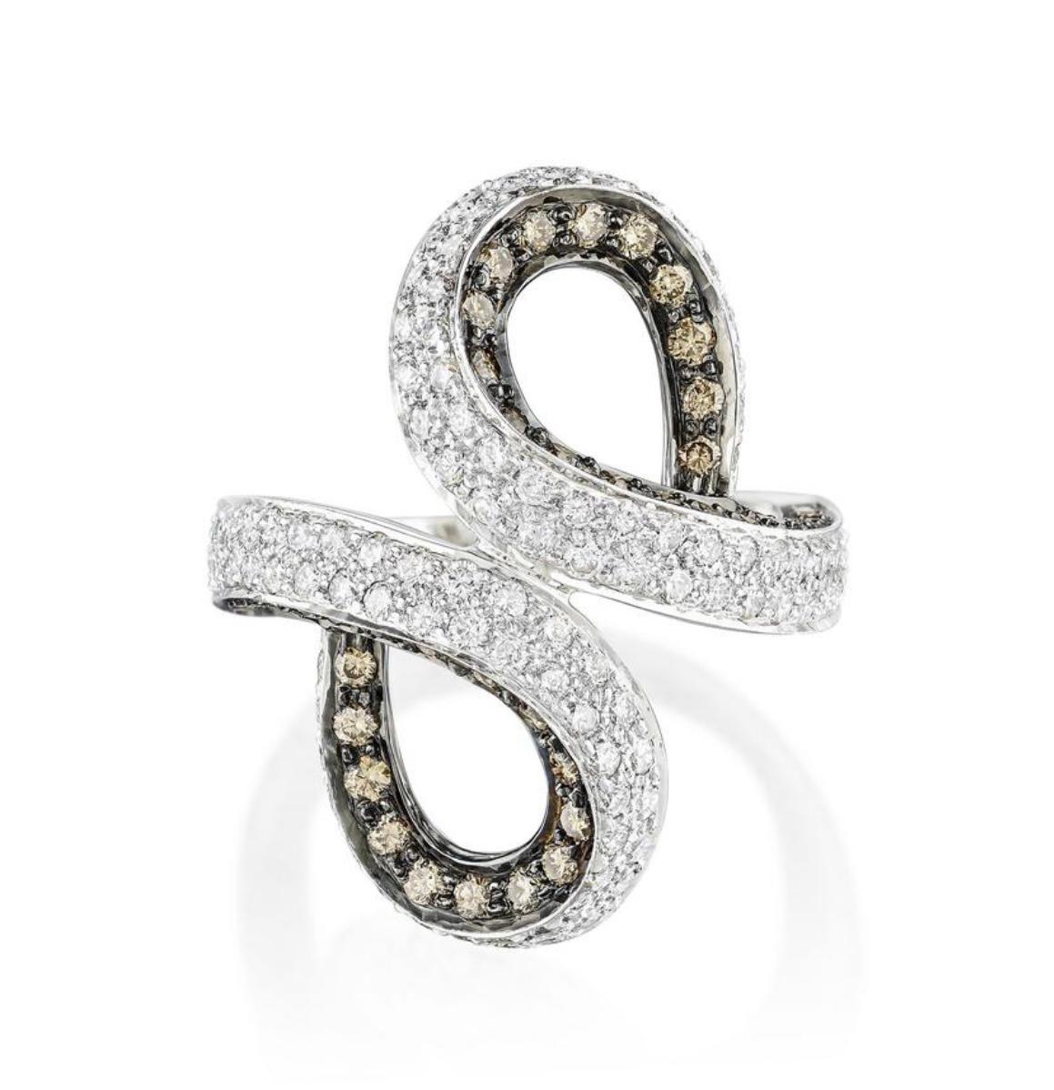 Smooth, curvy, big look but not bulky. 
This beautiful one of a kind ring is hand made in 18k white gold with white round brilliant diamonds weighing 2.44 carat with GH color and VS clarity and light brown diamonds weighing 0.88 carat. The ring size