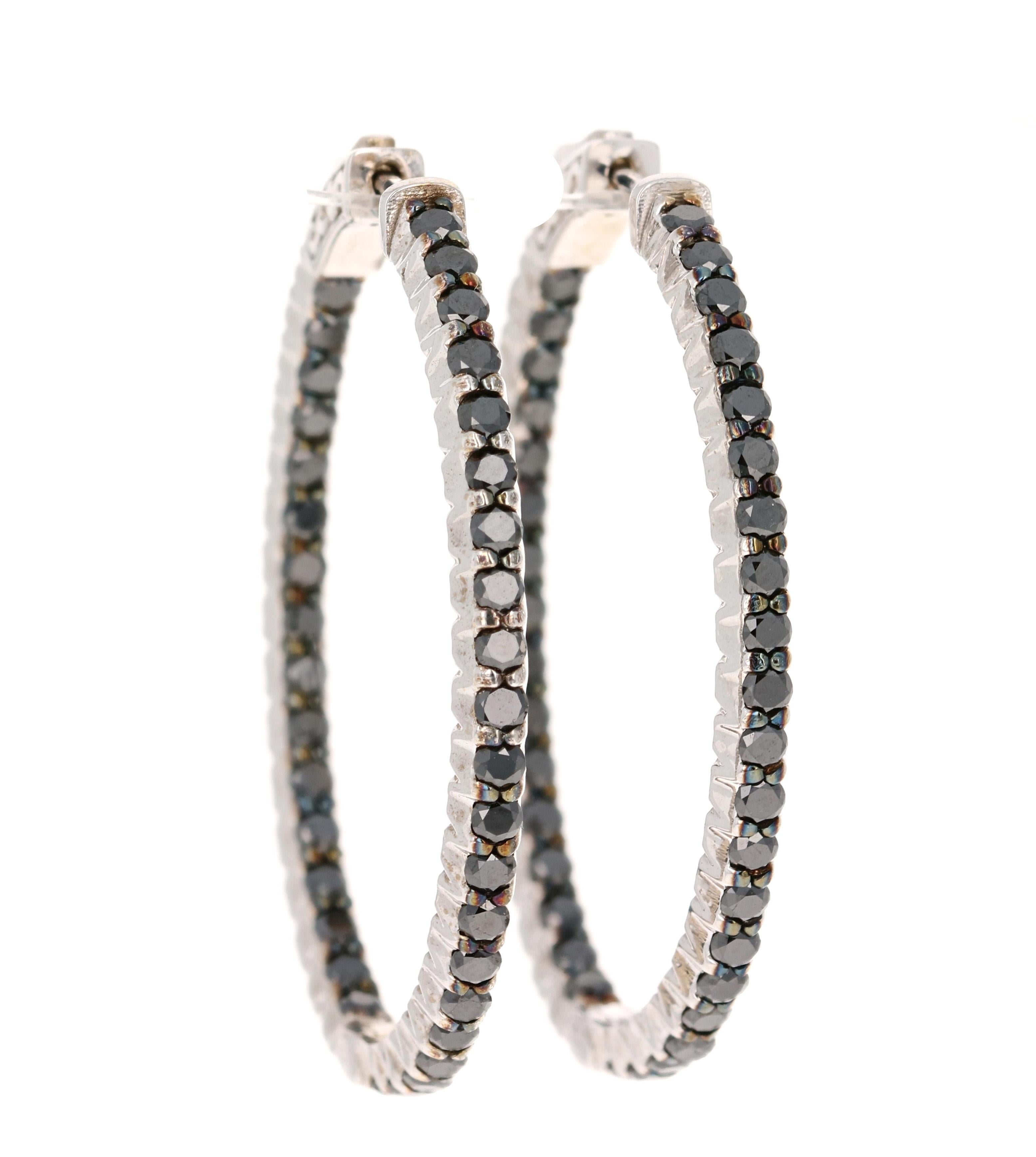 These hoop earrings have 74 Round Cut Black Diamonds that weigh 3.33 carats. 

They are set in 14 Karat White Gold and have an approximate gold weight of 11.1 grams.

The hoops are 1.25 inches wide and 1.5 inches long. 
