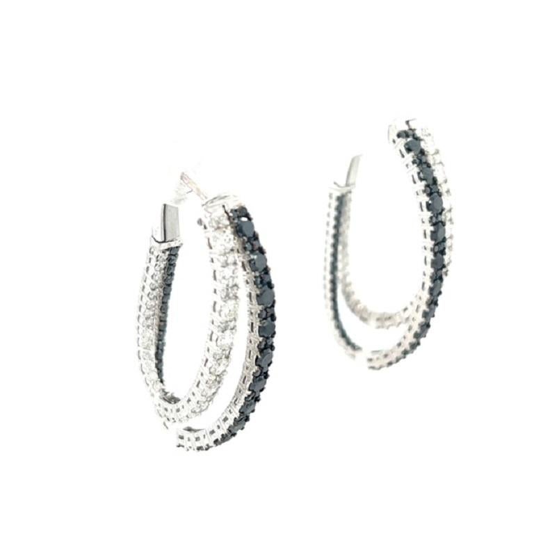 These hoop earrings have Natural Round Cut Black Diamonds that weigh 1.64 carats and Natural Round Cut White Diamonds that weigh 1.70 carats. The total carat weight of the earrings are 3.34 carats. 

They are set in 14 Karat White Gold and have an