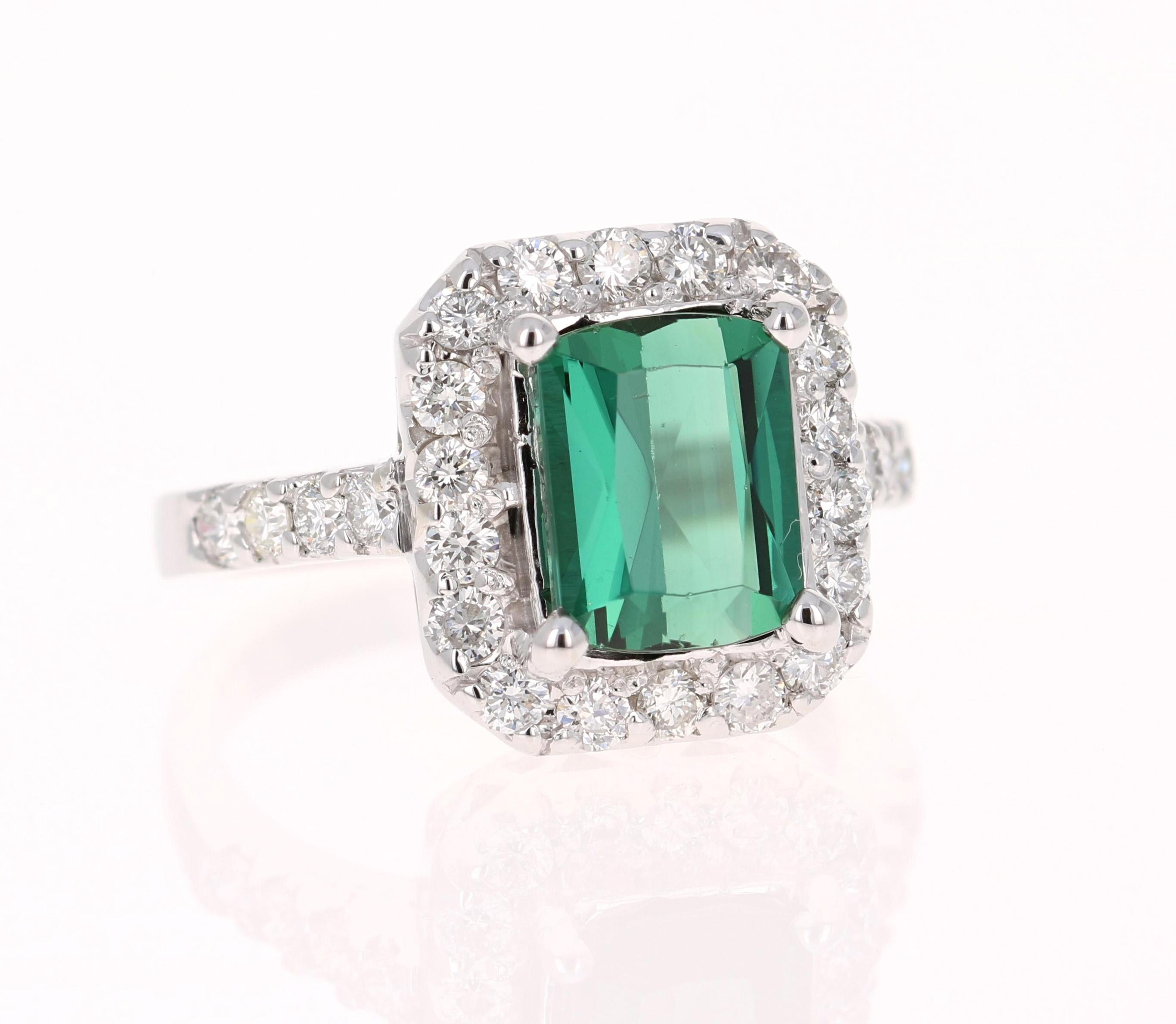 This ring has a magnificently beautiful Emerald Cut Green Tourmaline that weighs 2.45 Carats and has 26 Round Cut Diamonds weighing 0.89 Carats. (Clarity: VS, Color: F) The total carat weight of the ring is 3.34 Carats.

The green tourmaline is