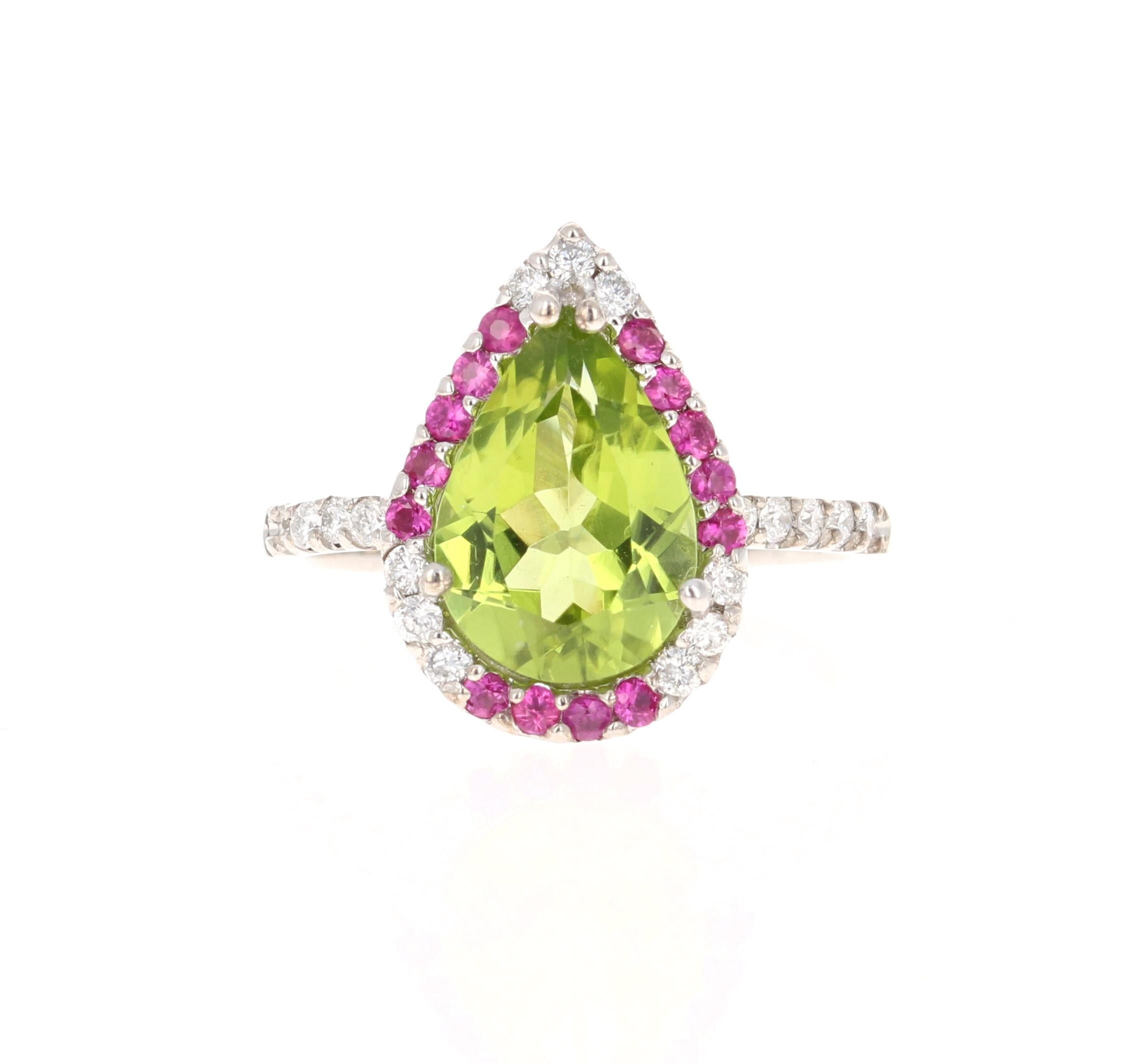 This beautiful ring has a Pear Cut Peridot in the center that weighs 2.77 carats. The ring is surrounded by a cute halo of alternating diamonds and pink sapphires. There are 21 Round Cut Natural Diamonds that weigh 0.31 carats and 14 Pink Sapphires