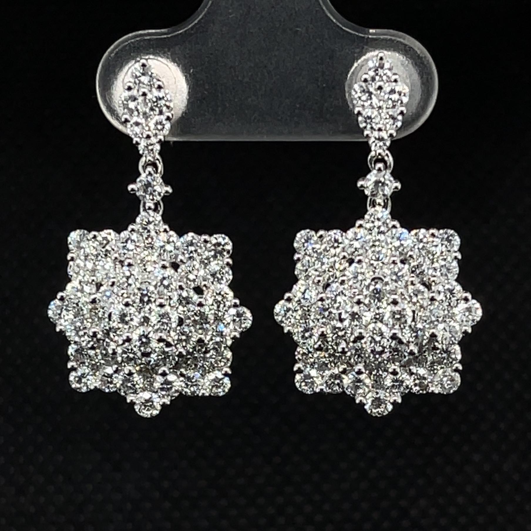 These stunning earrings are absolute visions of beauty. Bursting with over 3 carats of fine quality round brilliant cut diamonds set in 18k white gold, they are starry snowflakes fit for an angel. They are the perfect 