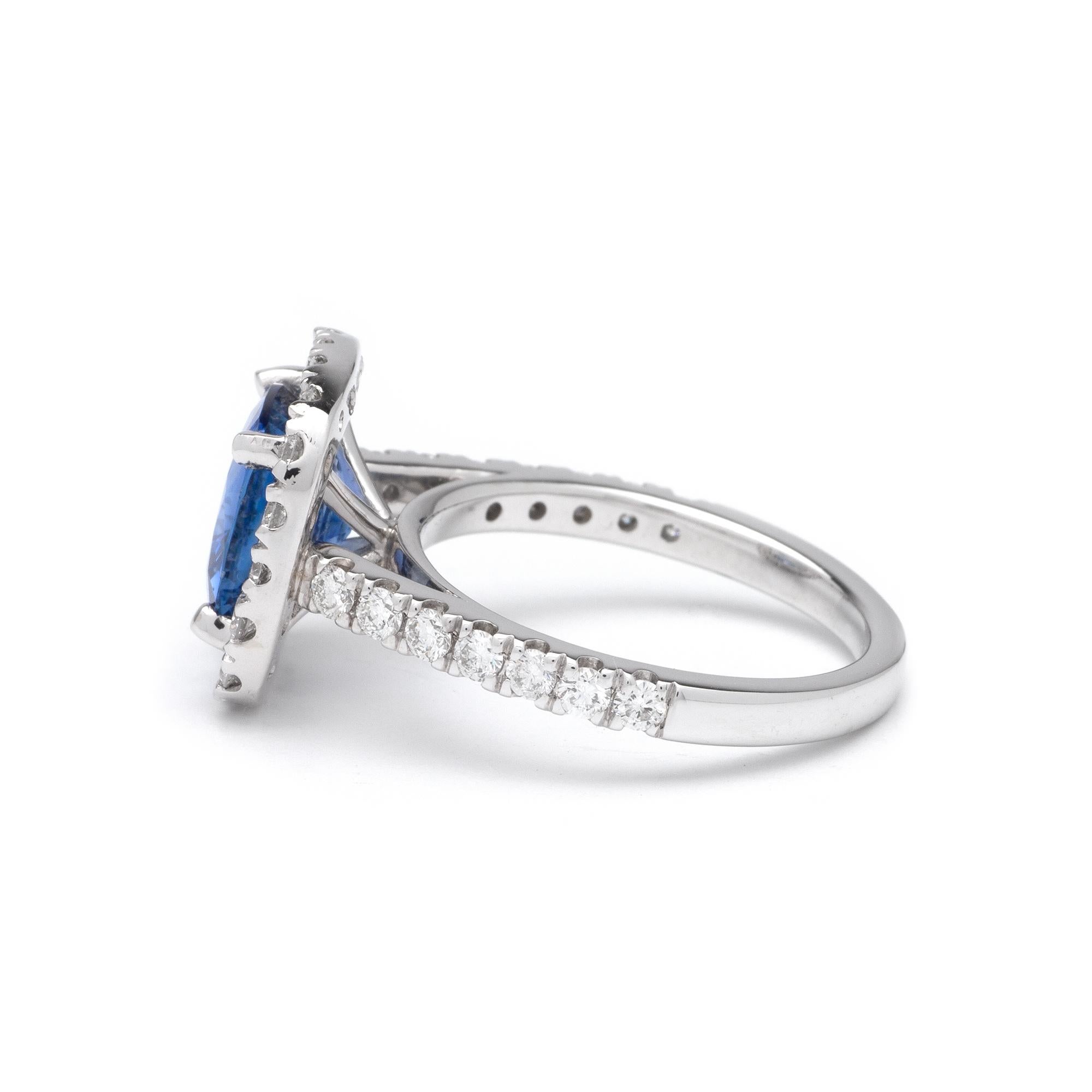 This ring features a halo design of G color, VS1 clarity, and 1.00ct Round side diamonds set in 14K white gold. The center gemstone is a 3.34ct Oval blue sapphire measuring 9.00 x 8.82mm. Finger size 6 1/2.