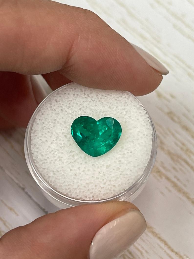 Stone: Emerald
Weight: 3.35-carats
Shape: Heart Cut
Clarity: Transparent
Luster: Very Good
Color: Vivid Dark Muzo Green
Measurements: 11.14mm x 8.83mm x 6.63mm
Geographic Origin: Colombia
Treatment: Natural, Moderate Oil

Comments: Due to their