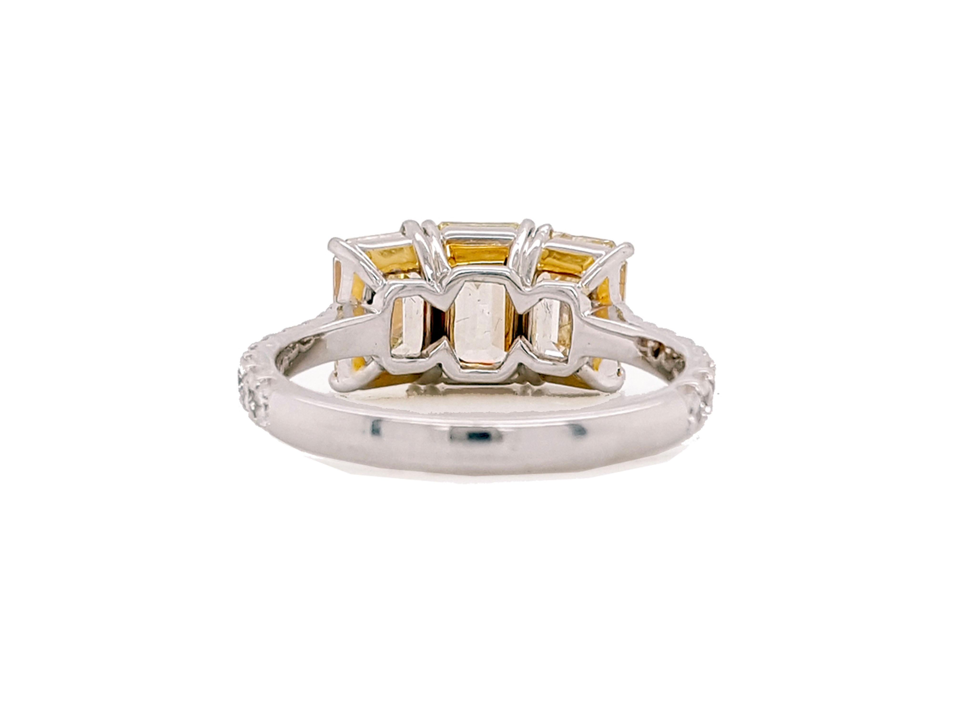 Contemporary 3.35 Carat Yellow Diamond Emerald Cut Three-Stone Engagement Ring, Platinum. For Sale
