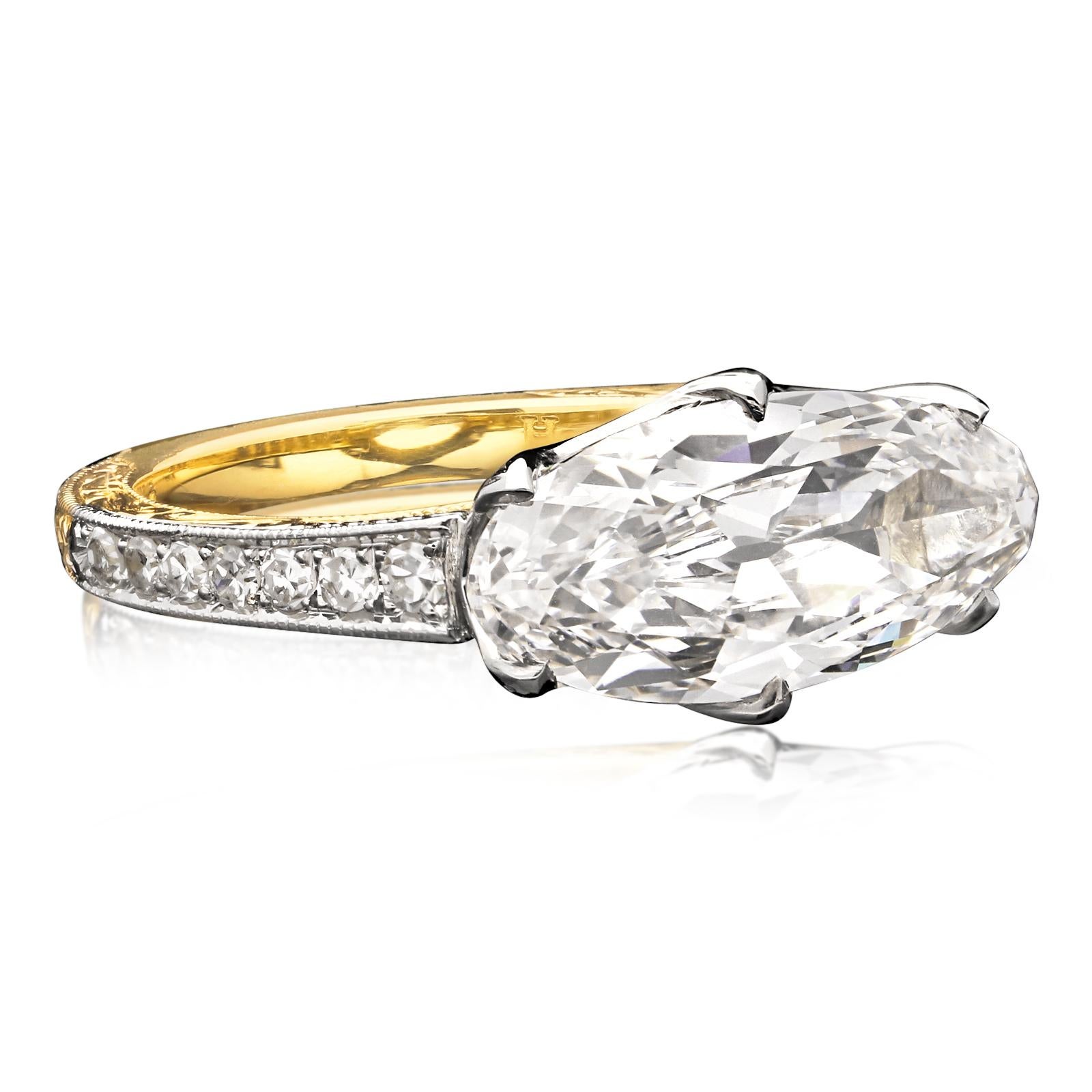 A stunning oval diamond ring by Hancocks centred with an elongated old-cut oval brilliant diamond weighing 3.35ct and of H colour and VS2 clarity, horizontally set in a platinum scalloped gallery to a finely crafted 18ct yellow gold band with