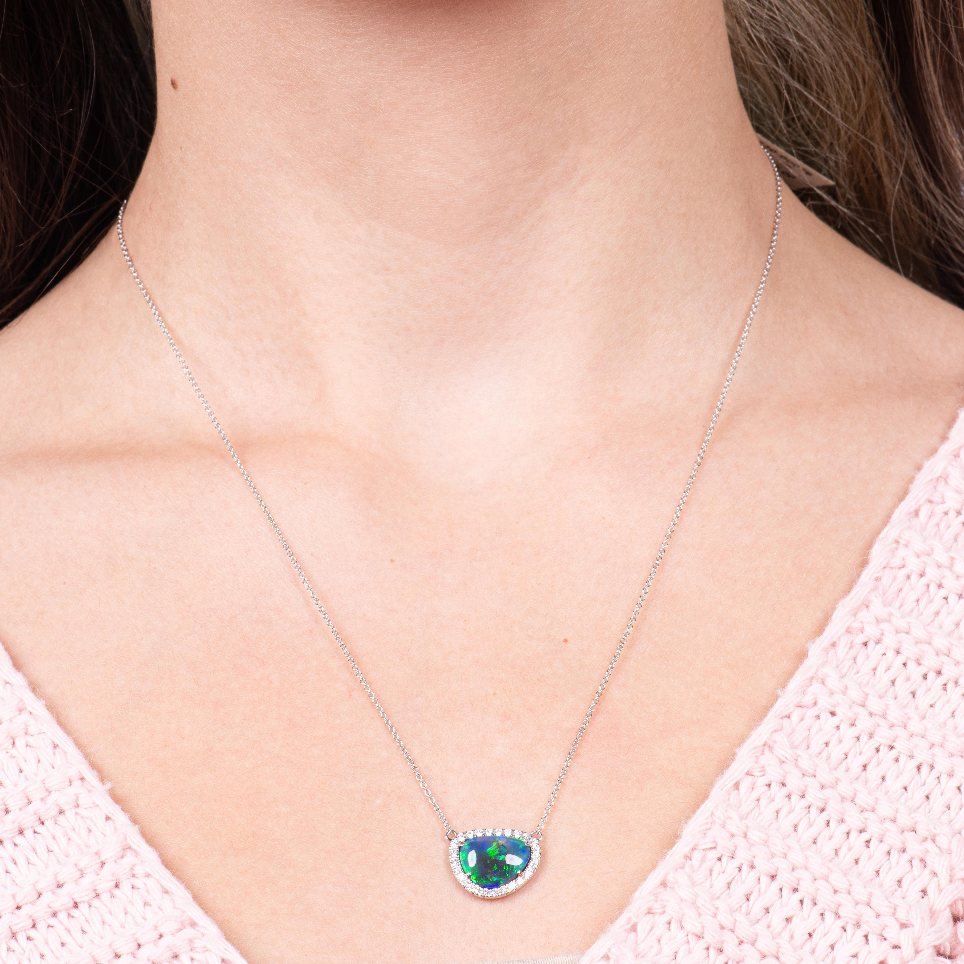 This pendant features a 3.35ct Lightning Ridge Australian blue/green opal, surrounded by a 0.27ctw diamond halo, set in 18kt white gold.