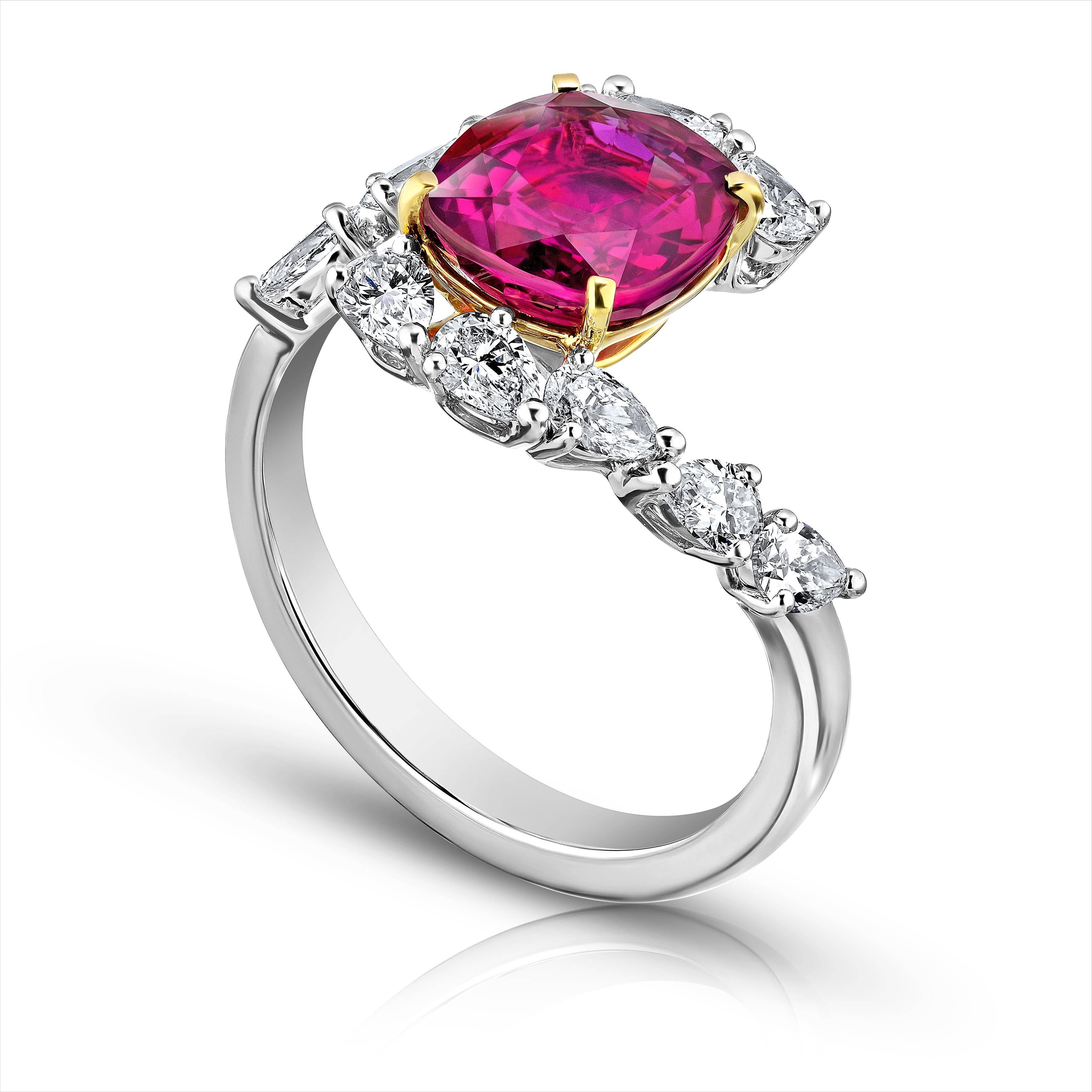 3.36 carat cushion red ruby (Ceylon) with 10 pear shape diamonds .98 carats set in a platinum and 18k yellow gold ring. This ring is a work of ant with a magnificent ruby. Its currently a size 7 but we will resize to your finger size at no charge. 
