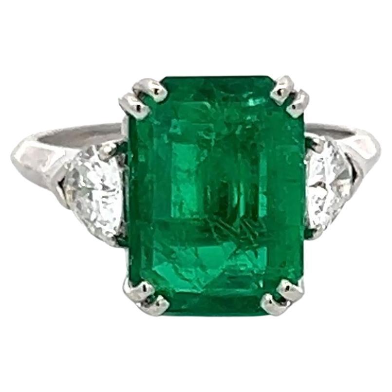 3.36 Carat Emerald 0.60 Carat Triangular Shape Diamond Platinum Engagement Ring