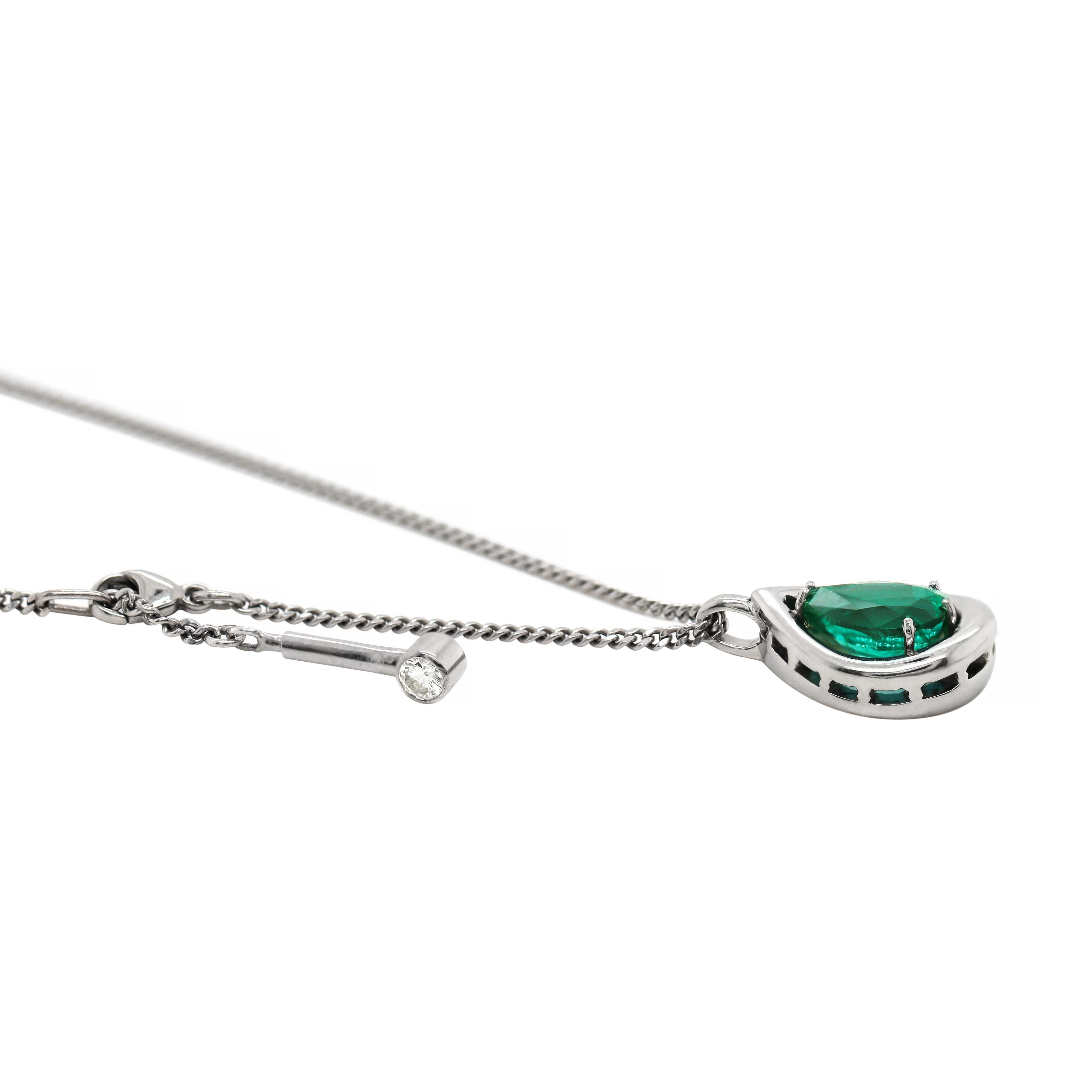 This lovely hand made necklace features a tear drop solid platinum pendant, set with a pear shaped emerald in the centre weighing 3.36ct. The pendant hangs from a fine platinum 15
