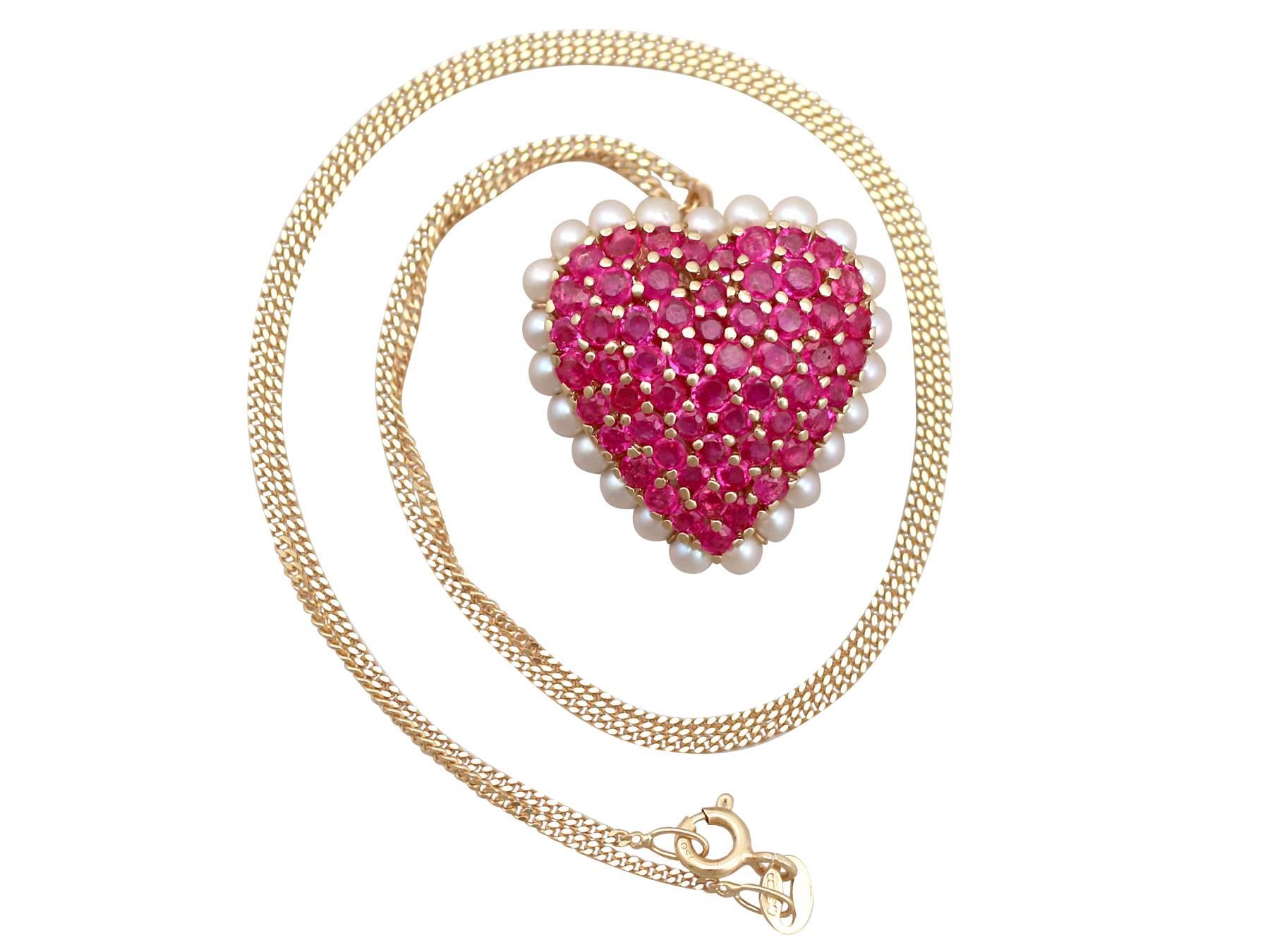 An impressive contemporary 3.36Ct ruby and seed pearl, 14k yellow gold heart brooch and 18k yellow gold chain; part of our diverse gemstone jewelry collections.

This fine and impressive contemporary ruby heart pendant with pearls has been crafted