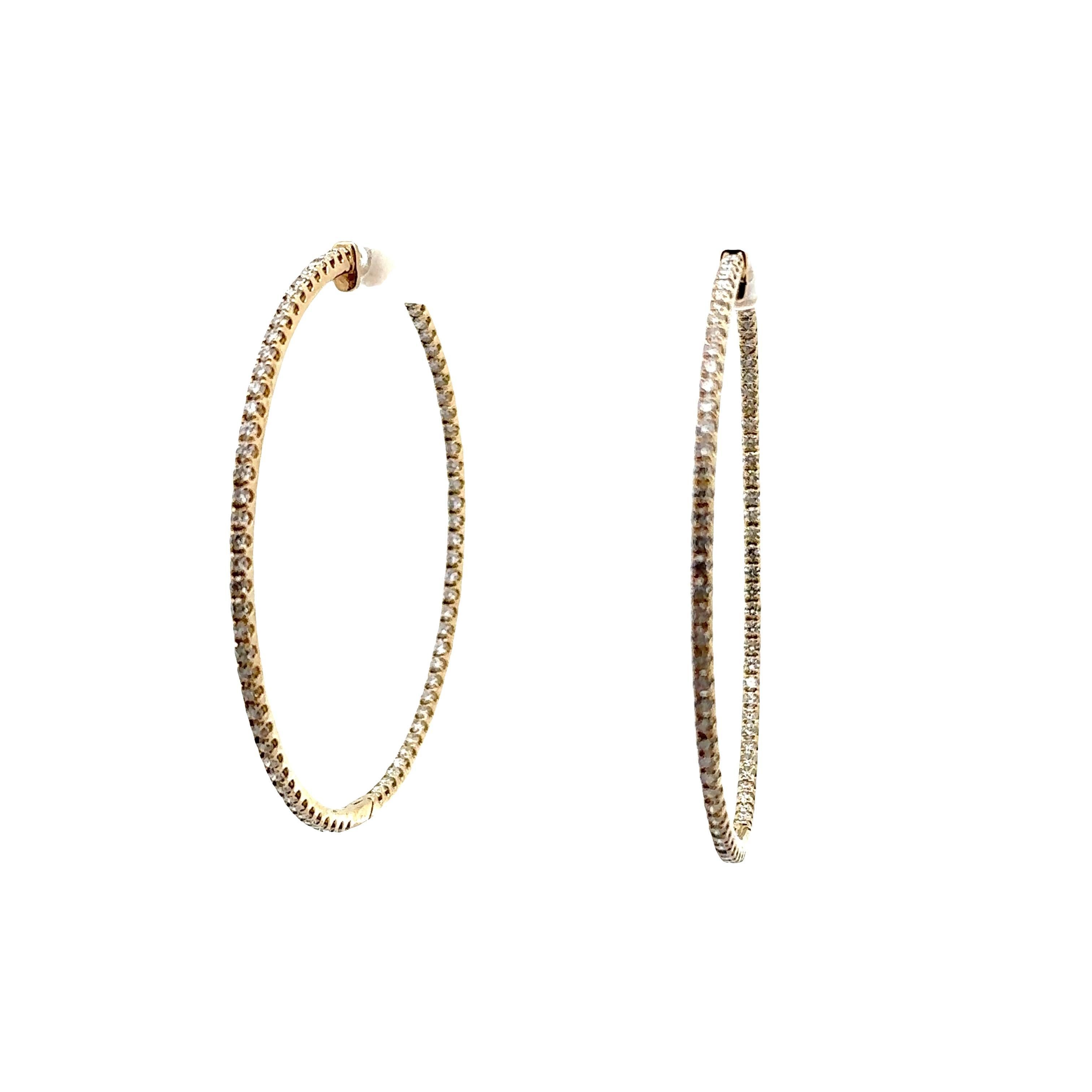 Crafted in 14k yellow gold, these exquisite hoop earrings are a captivating addition to any collection. Featuring 3.36 carats of round-cut white diamonds, the design is both luxurious and refined. These earrings embody a contemporary aesthetic with
