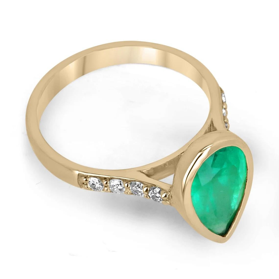 Displayed is a bezel pear emerald and diamond solitaire engagement ring/right-hand ring in 18K yellow gold. This gorgeous solitaire ring carries a full 3.16-carat emerald in a bezel setting which adds extra protection for the stone. Fully faceted,