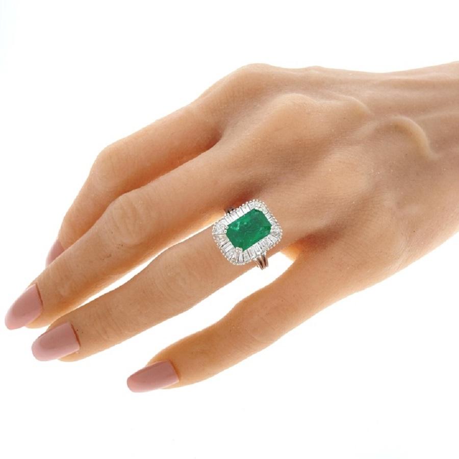 Eine atemberaubende Kombination aus natürlicher Schönheit und zeitloser Eleganz: unser exquisiter Ring mit einem grünen Smaragd von 3,37 Karat, verziert mit 28 Baguette-Diamanten von insgesamt 2,10 Karat, gefasst in opulentem 18-karätigem Weißgold.