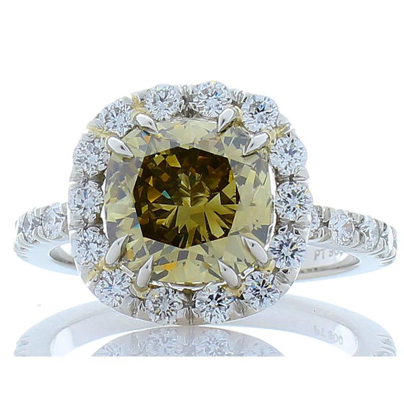 Breathtaking and incredibly unique, this gorgeous brightly polished platinum engagement cocktail ring boasts a 3.37 carat cushion cut natural fancy dark brown greenish-yellow diamond that displays a cognac shade prong set in the center. This diamond