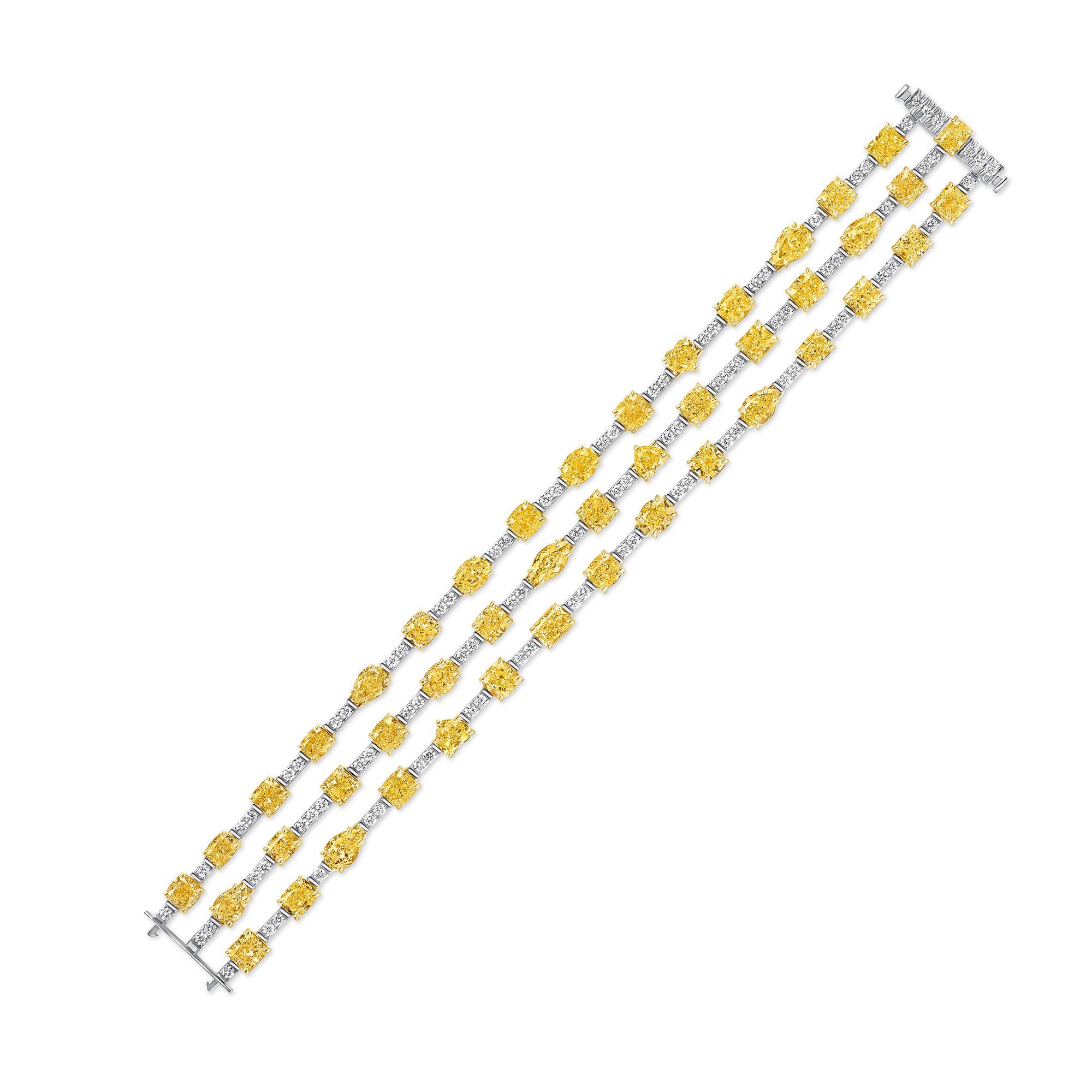 Three Row Fancy Shape Fancy Yellow Diamond Bracelet in 14K Gold. This bracelet sets with forty-five Fancy Shape Fancy Yellow diamonds weighs 31.17 carats and ninety-two round diamonds in F-G color, VS clarity weighs 2.53 carats. It has a total