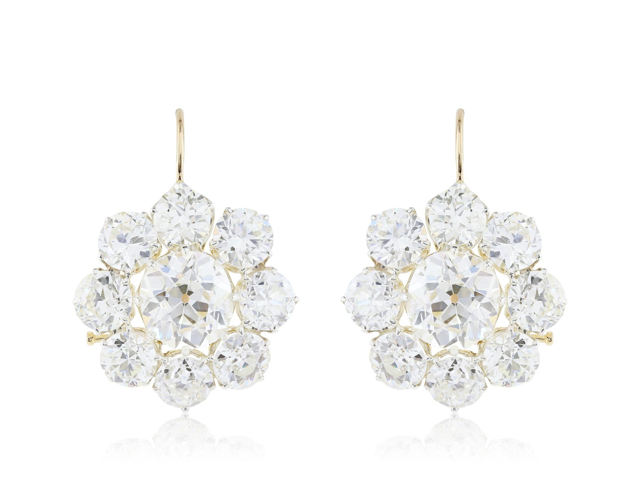 Custom made 18 karat yellow gold cluster earrings featuring 2 Old European cut diamonds, with total weight of 6.80 carats, surrounded by 16 Old European cut diamonds with a total weight of 13.48 carats, diamonds are graded approximately for color